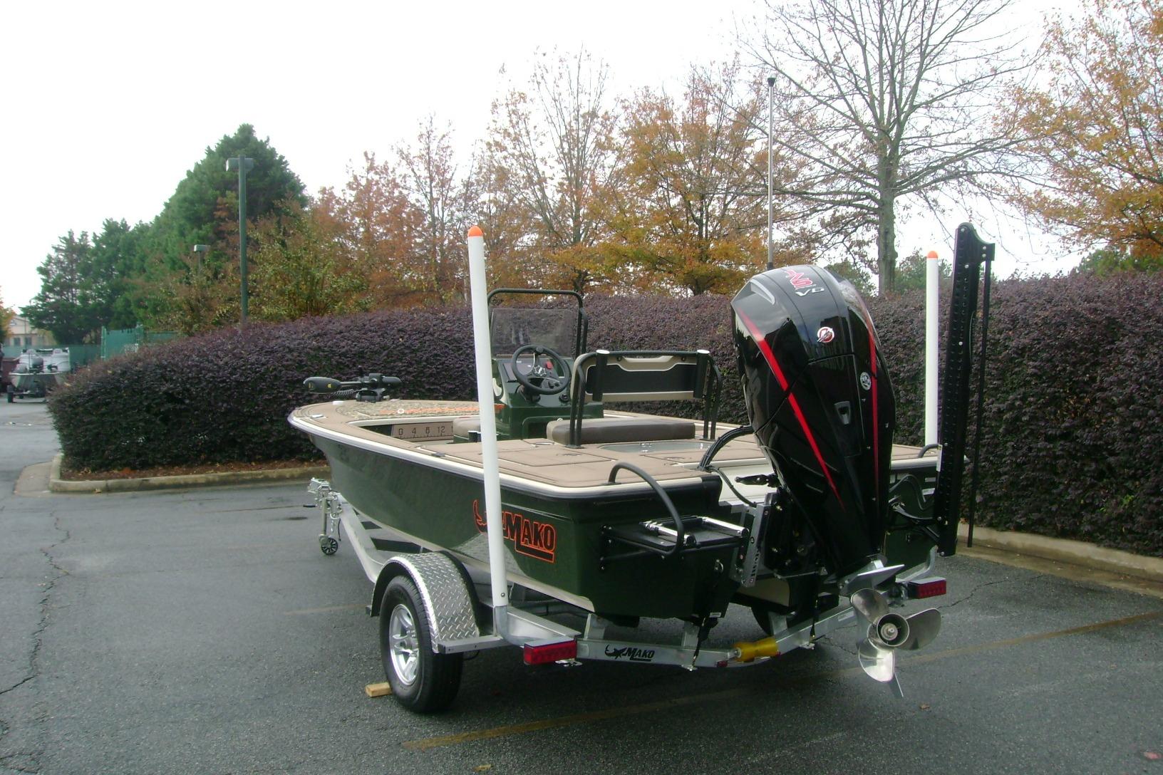 2025 Mako 18 Pro Skiff Backwater Edition boat on trailer in parking lot.