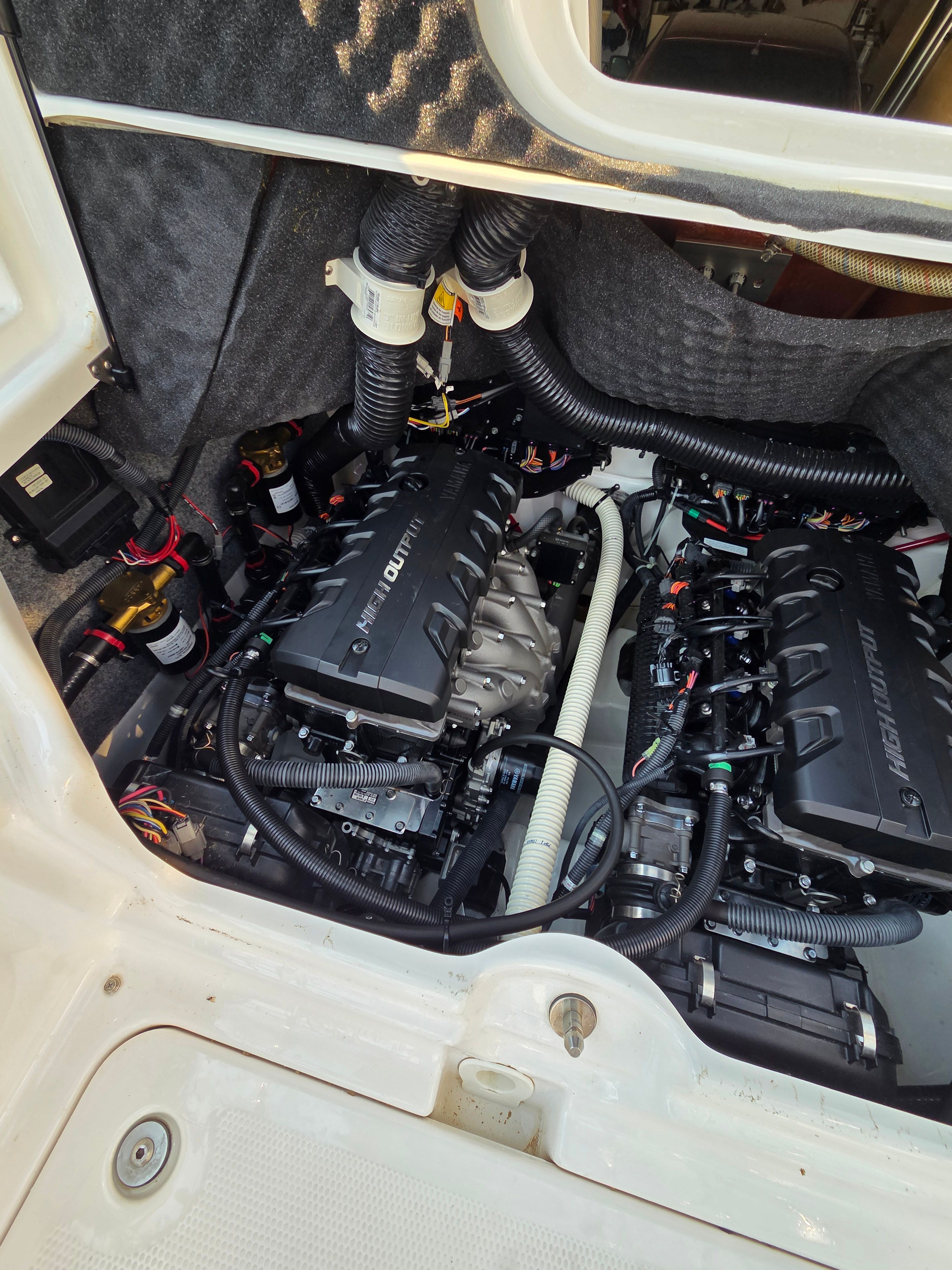 The engine compartment of a 2016 Yamaha 242X E-Series boat with two powerful engines.