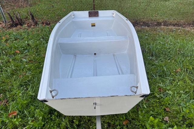 1999 Beacon Boats Pram on grass, showcasing interior seating and structure.