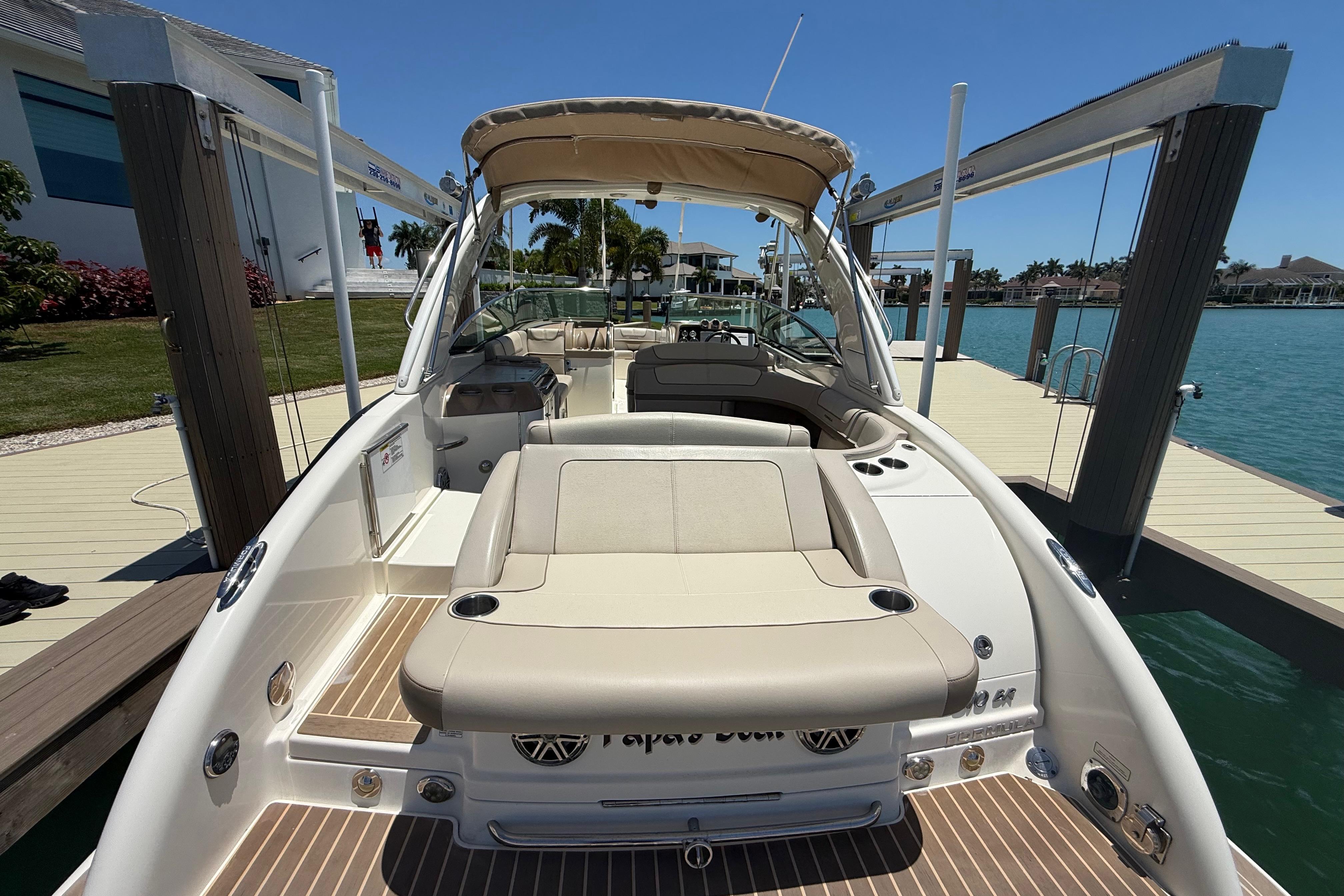 2015 Formula 310 Bowrider docked, showcasing spacious seating and sleek design.