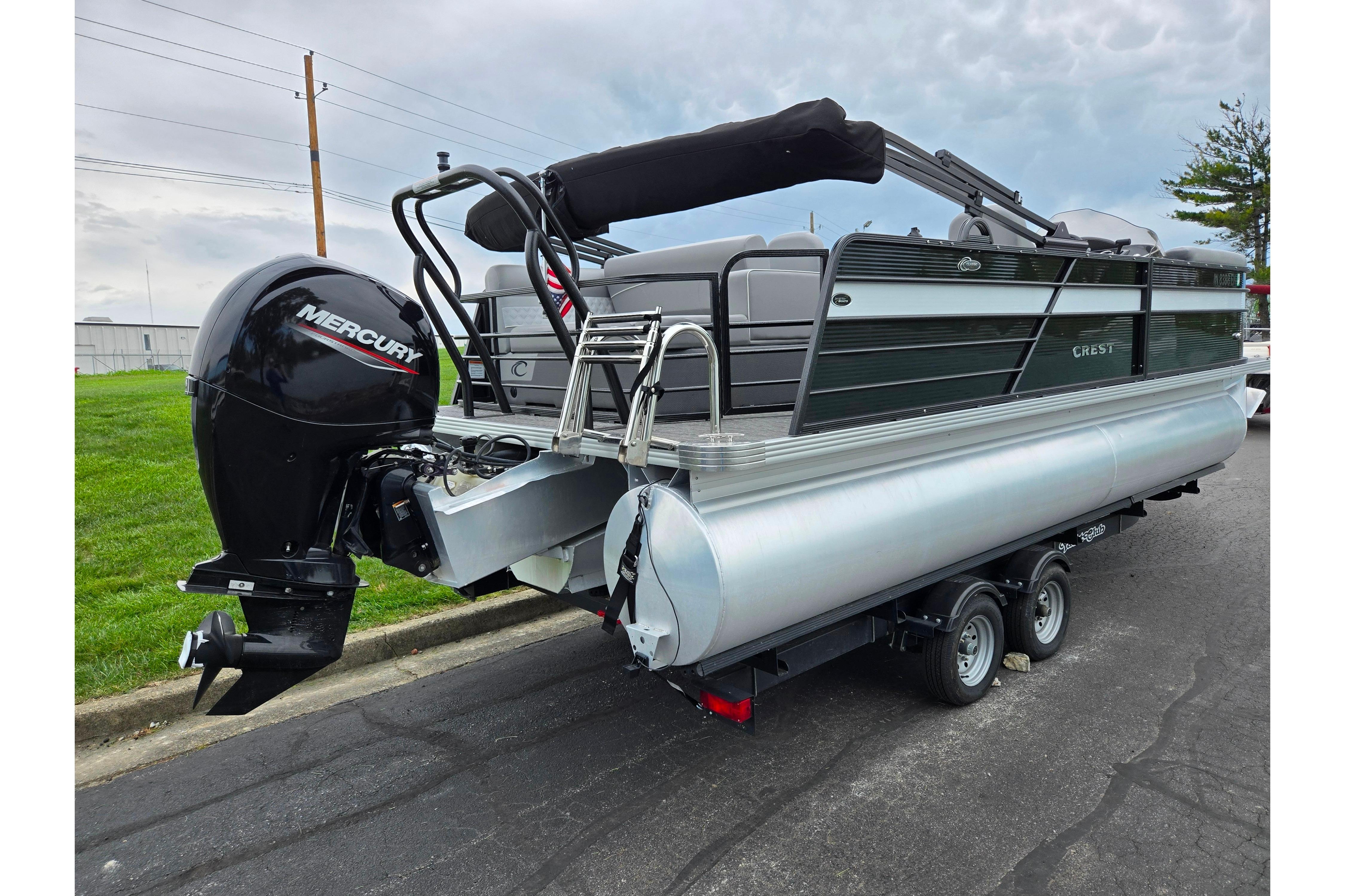 2022 Crest Classic DLX 220 pontoon boat with Mercury outboard motor on trailer.