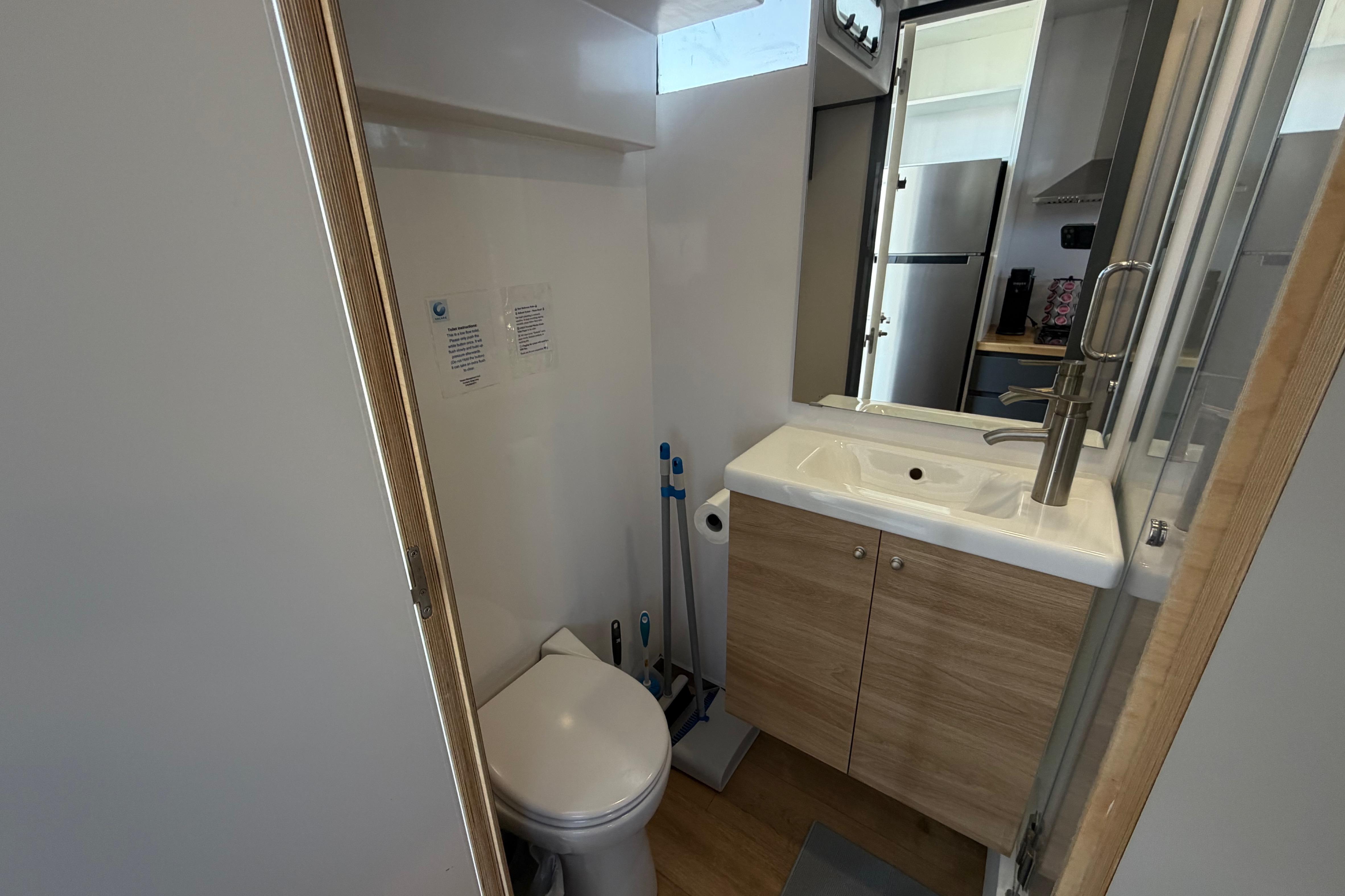 Compact bathroom in 2022 Navisyo NV.08 with modern sink and toilet.