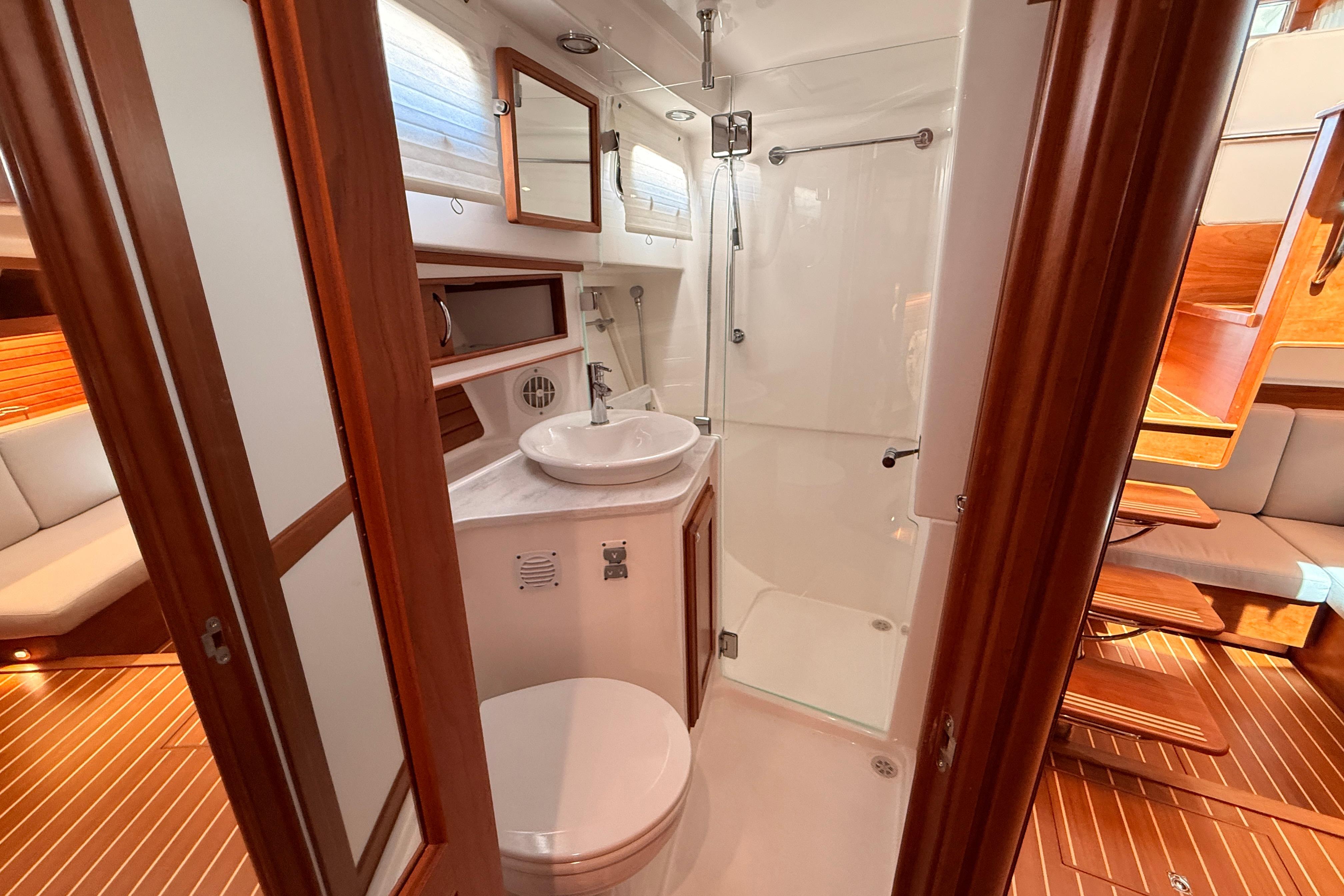 Luxurious bathroom interior of 2022 Sabre 38 Salon Express yacht with modern amenities.