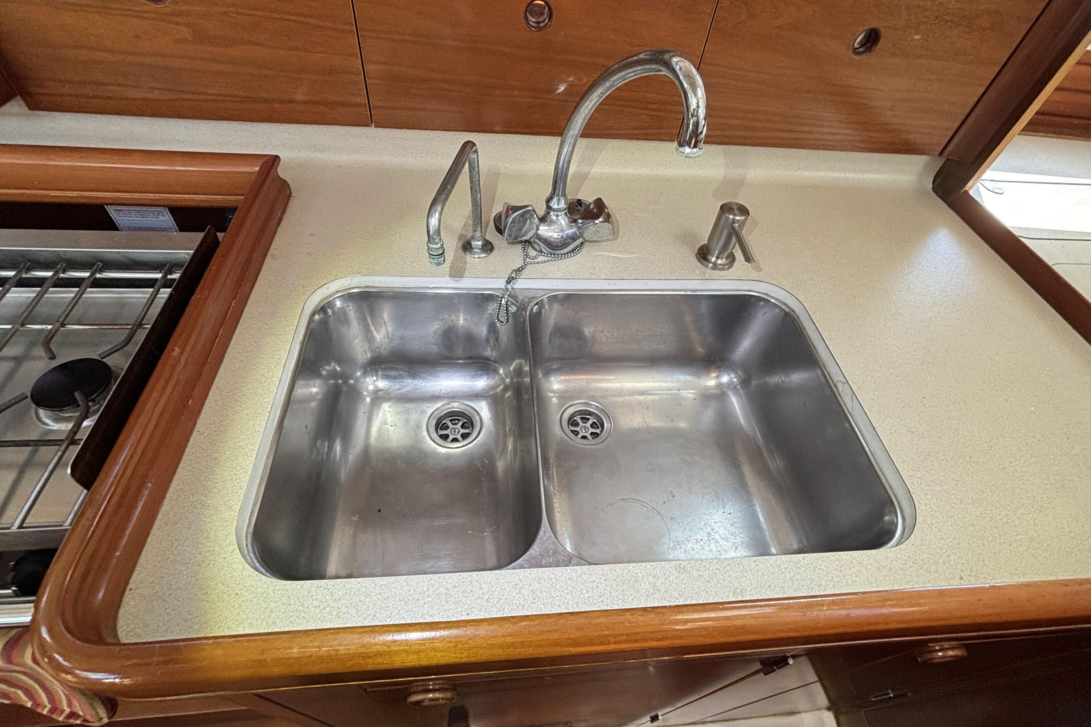 Stainless steel double sink in 1997 Beneteau Oceanis 400 yacht kitchen.