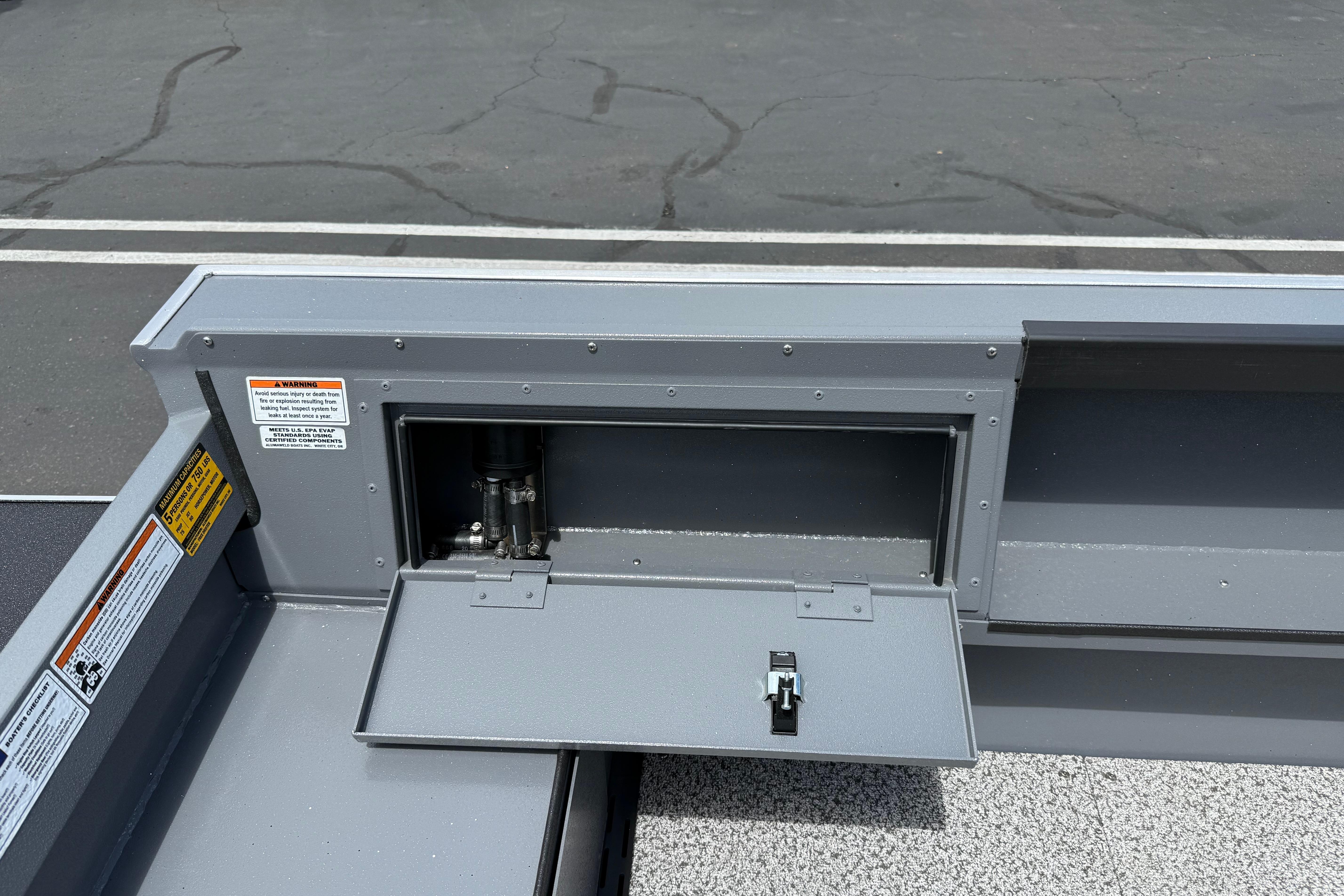 2026 Alumaweld Free Drifter 20 boat compartment with open hatch and visible hydraulic components.