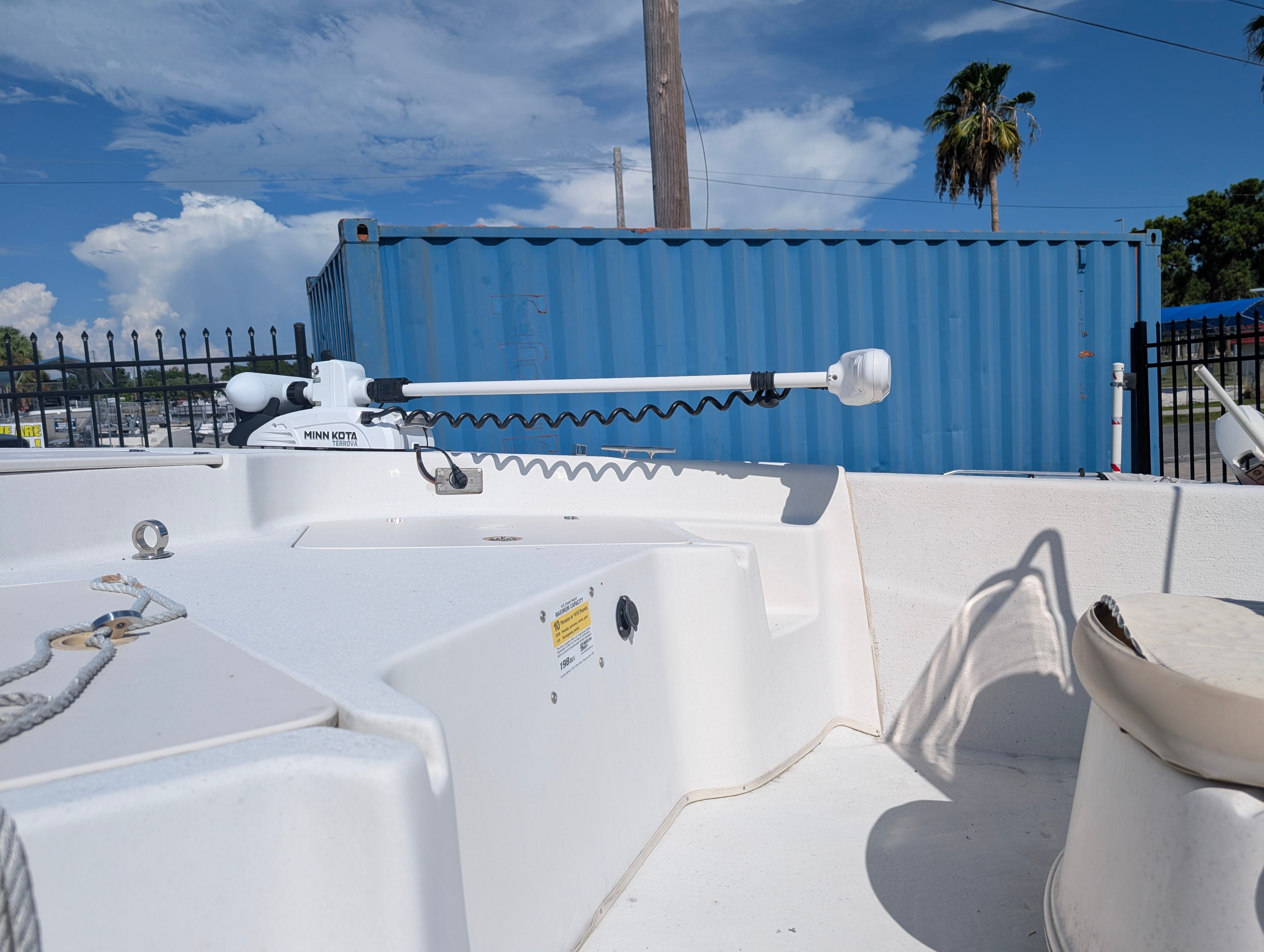 The image shows the deck of a 2016 Carolina Skiff 198 DLV with a Minn Kota trolling motor.