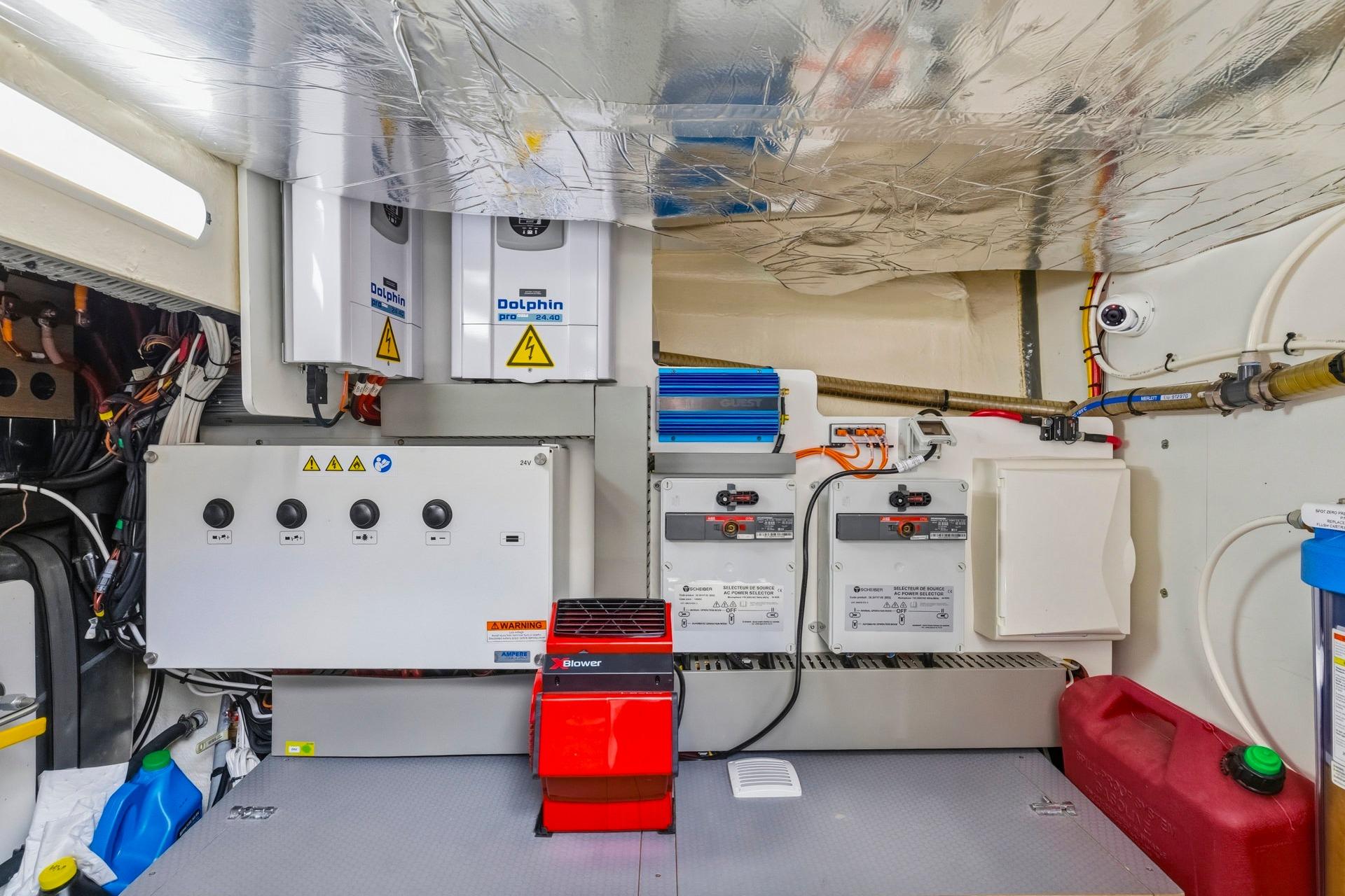 Engine room of a 2022 Prestige 520 yacht, featuring electrical panels and equipment.