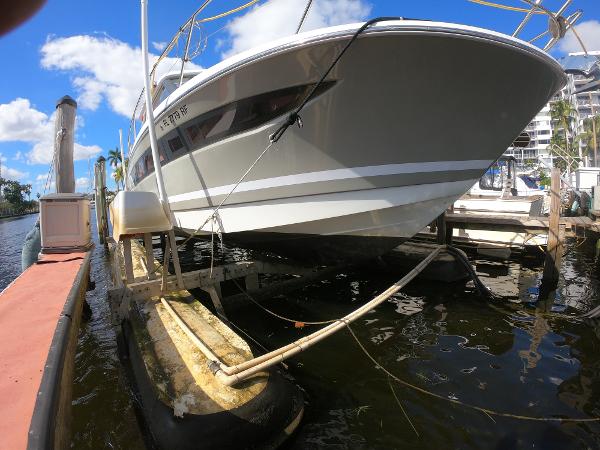 2017 Jeanneau NC 11 boat docked at marina under blue sky.