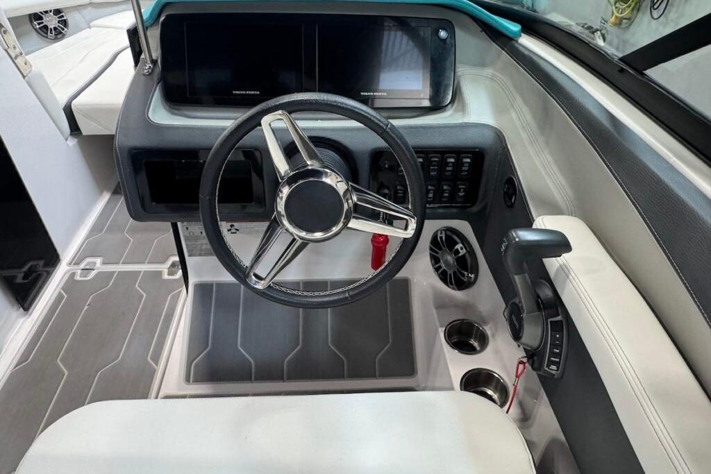 2022 Regal LS6 Surf boat cockpit with steering wheel and control panel.
