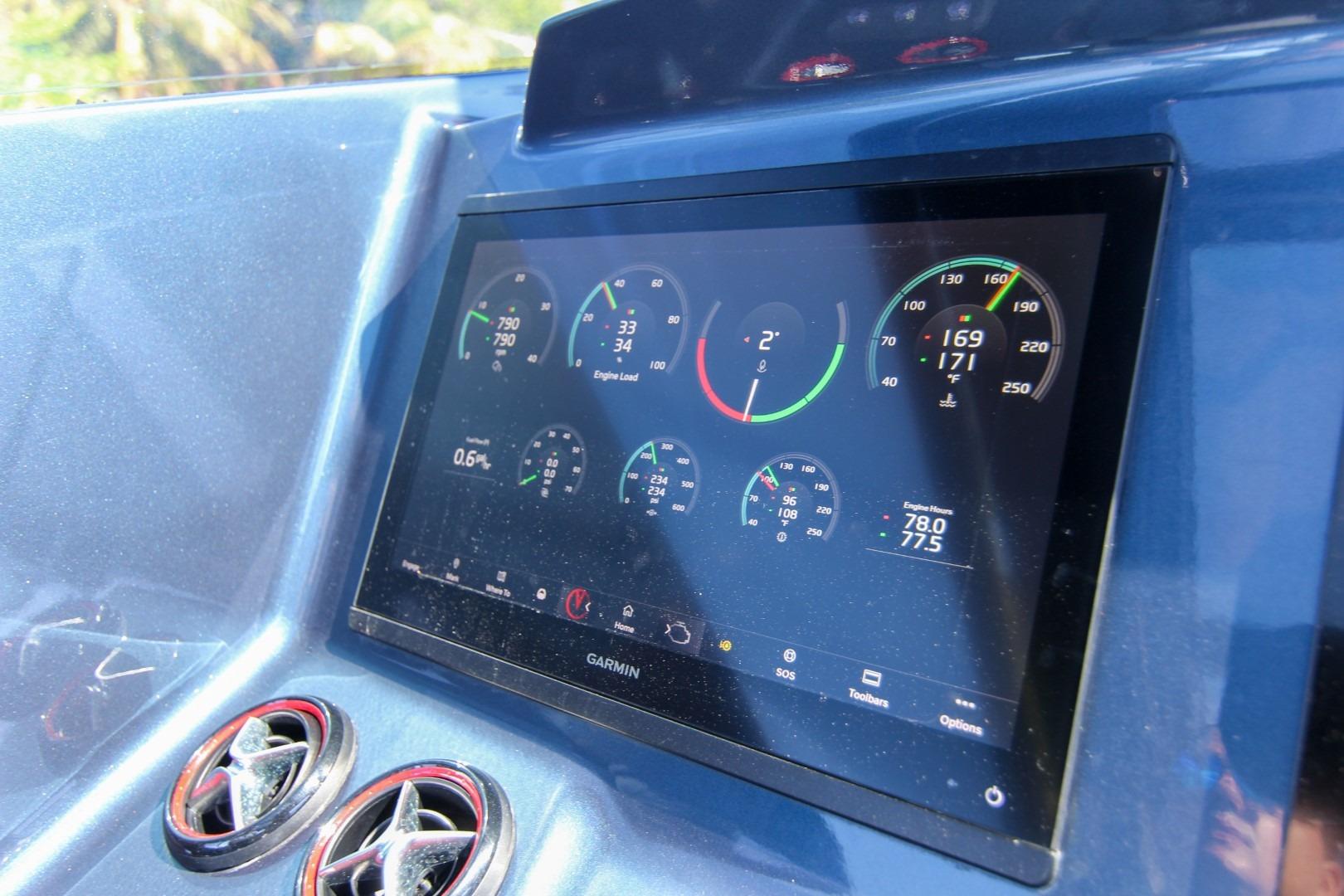 Dashboard of 2022 Vanquish Yachts VQ45 with Garmin display showing engine metrics.