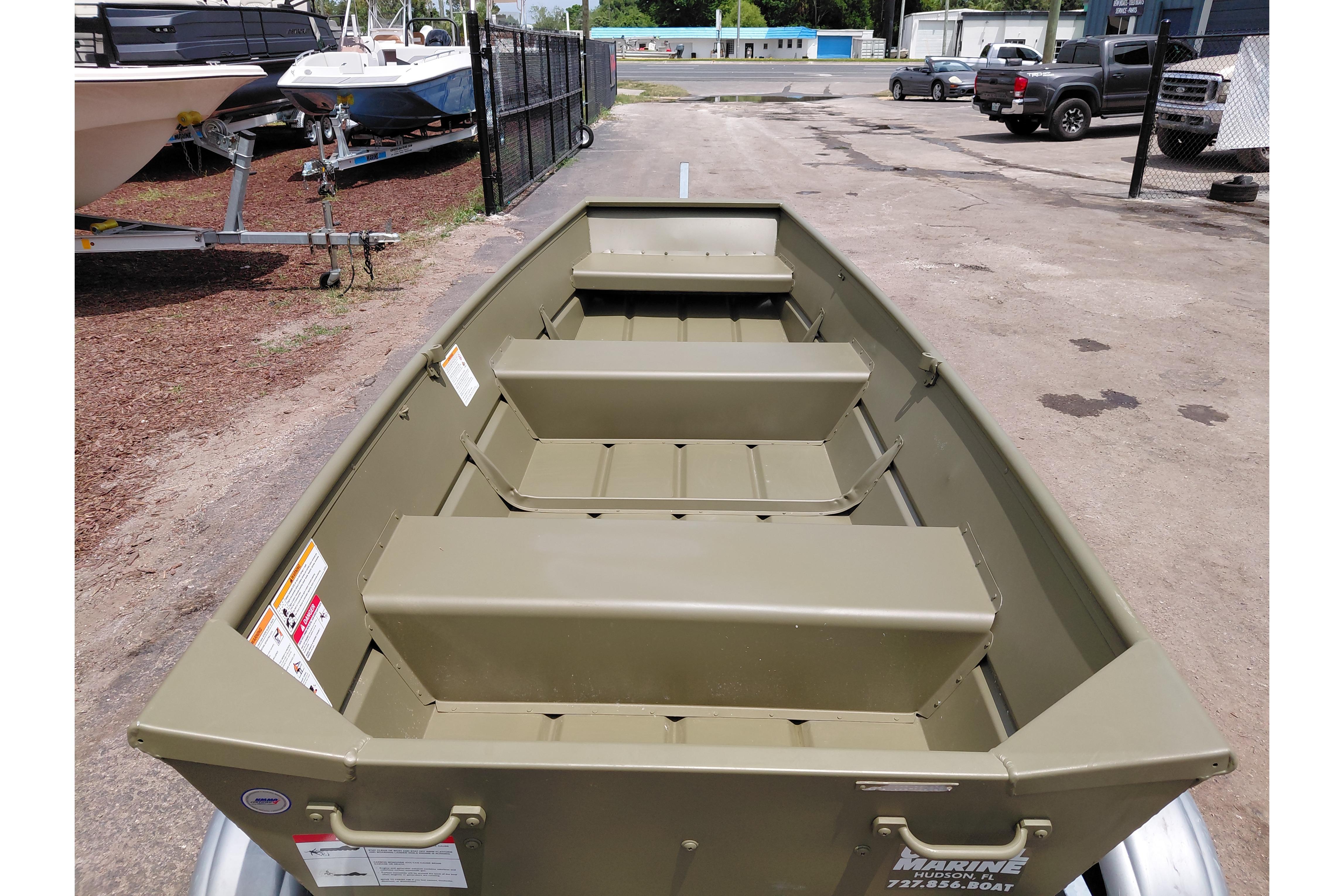 2026 Lowe L1032 Jon boat in a parking lot, showcasing interior seating and design.