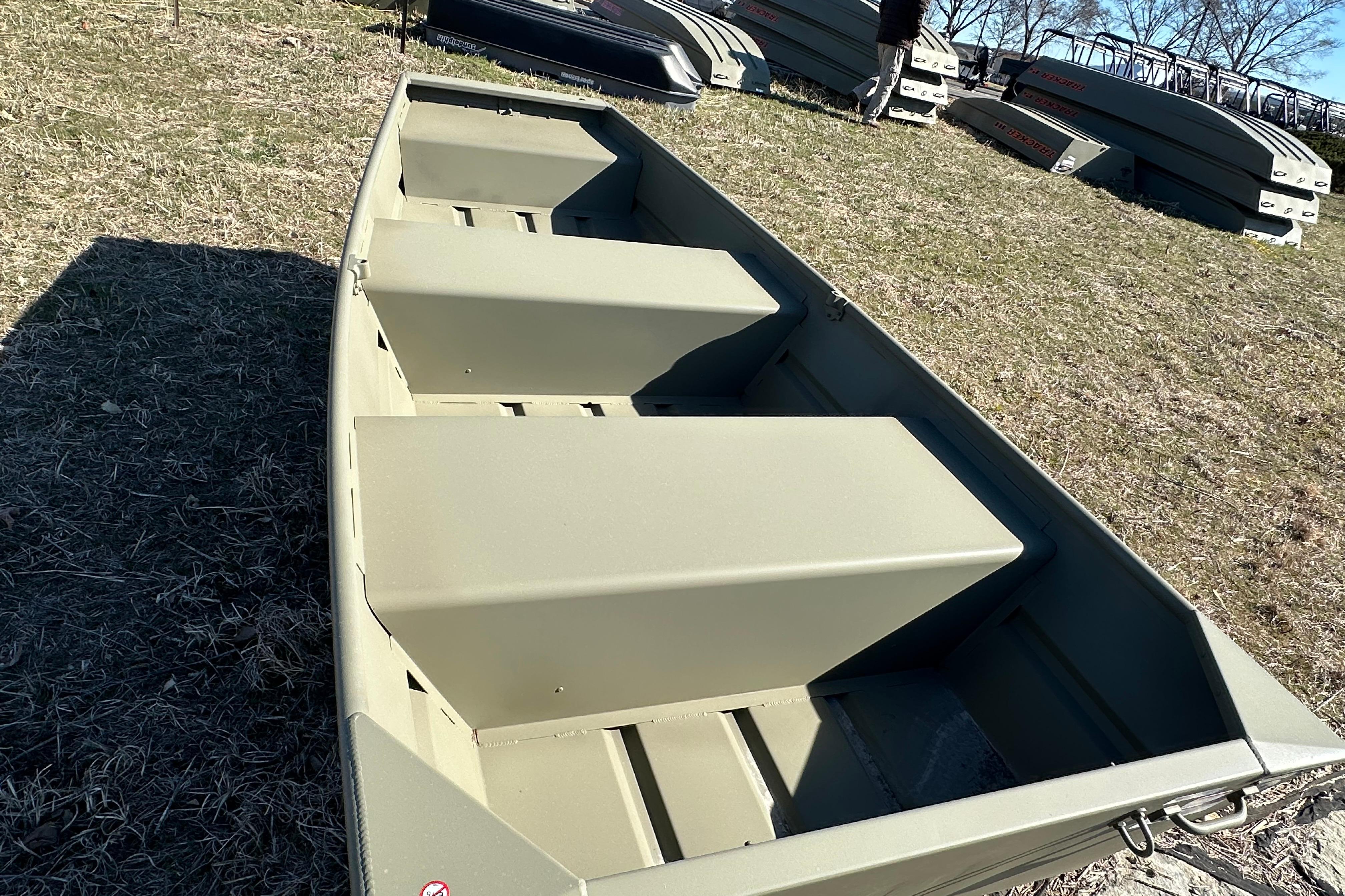 2026 Tracker Grizzly 10 Jon boat on grassy field, showcasing interior seating.