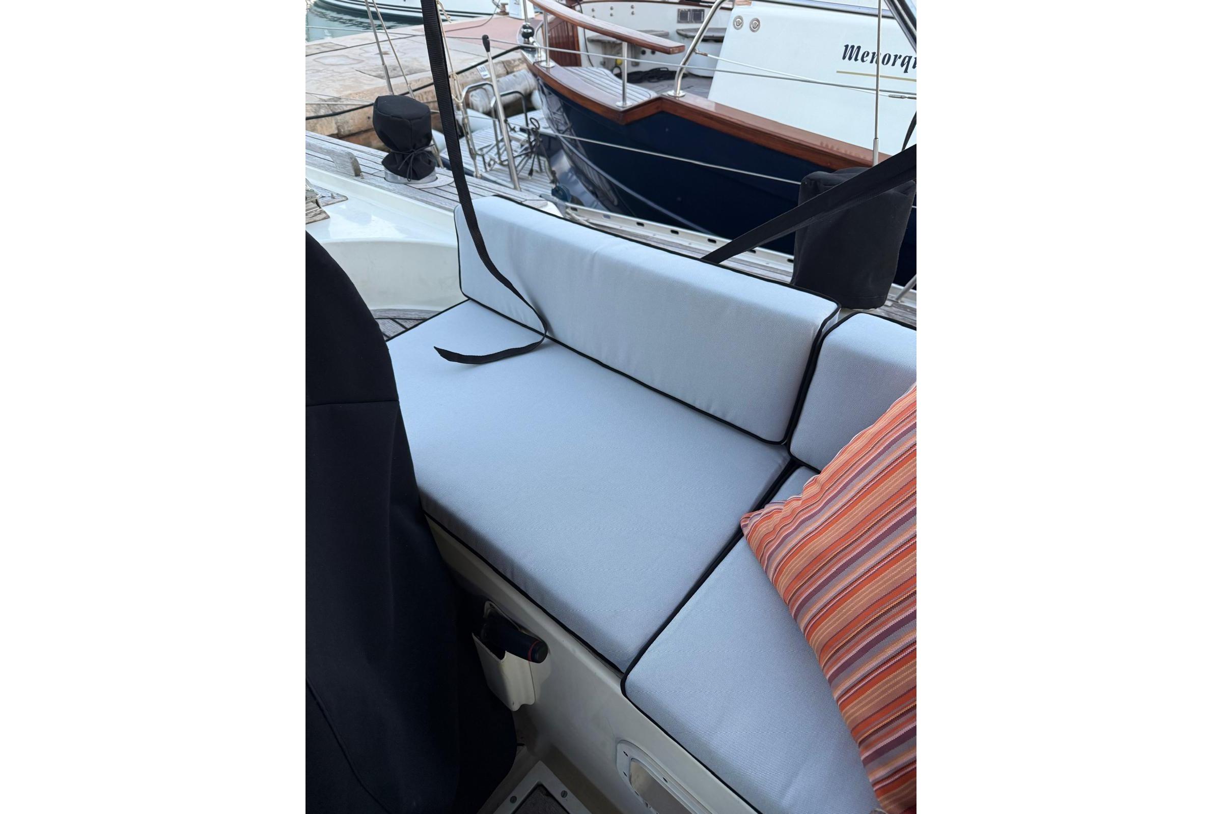 Comfortable seating area on a 1985 Oyster 435 yacht with striped cushion.