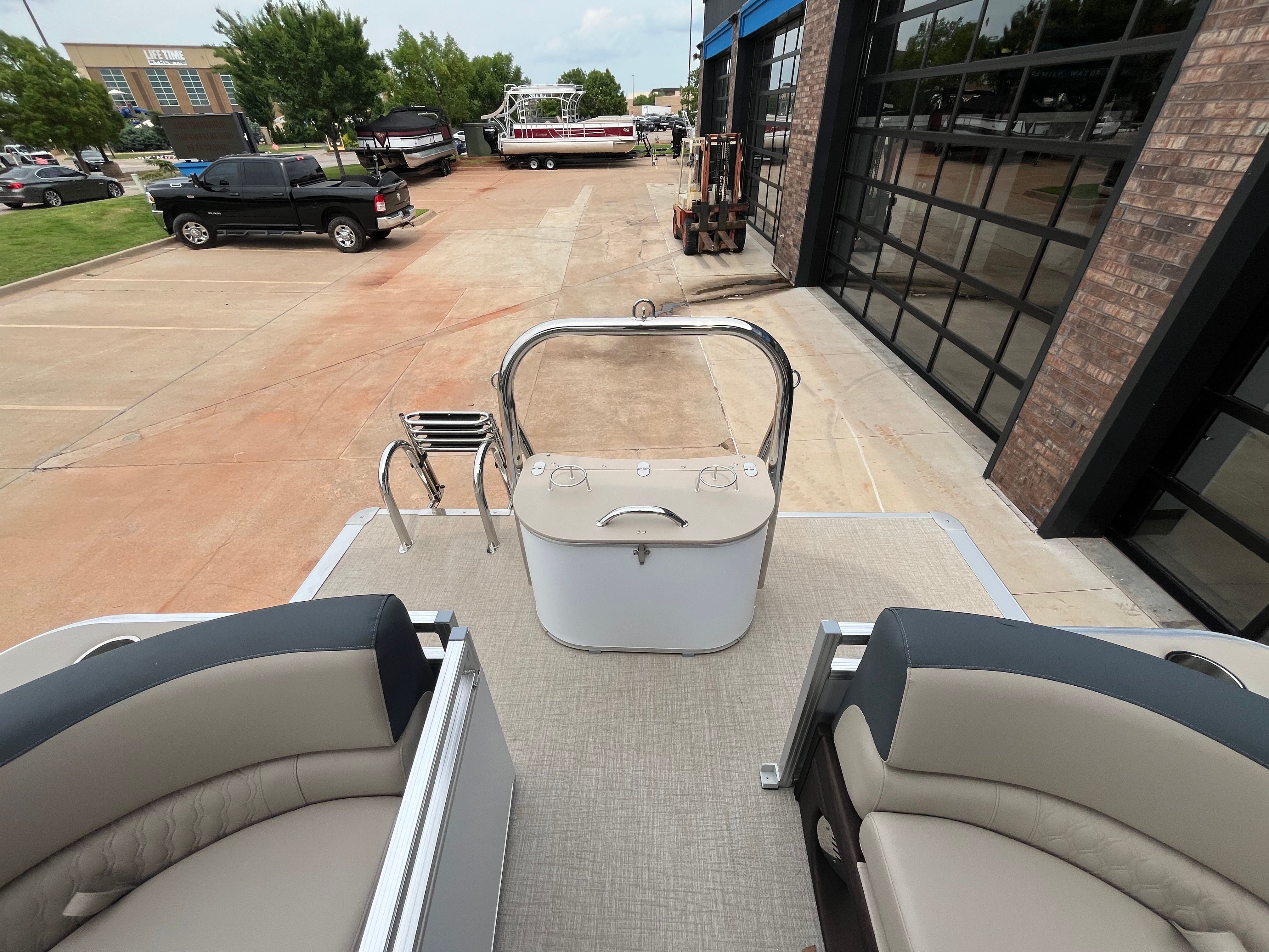 2025 Tahoe LTZ QL pontoon boat on parking lot near building.