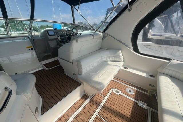 2004 Cruisers Yachts 3372 Express interior with white seating and wood flooring.