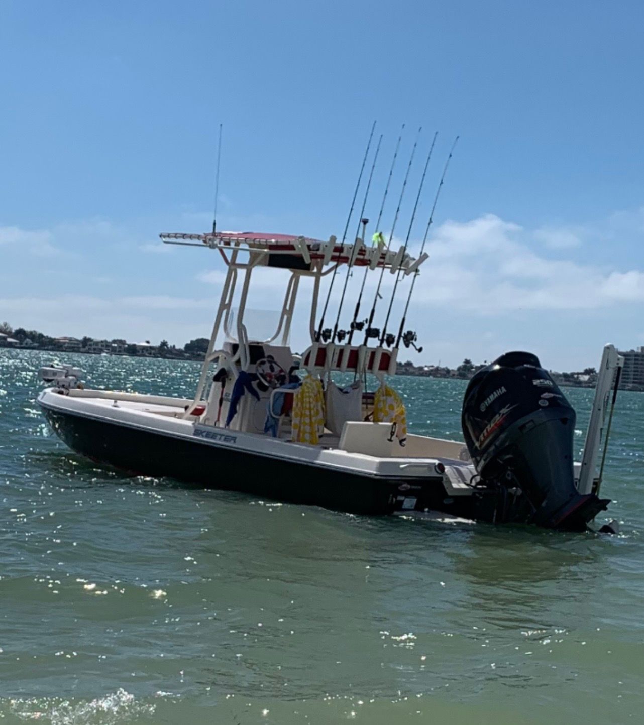 2016 Skeeter SX230 boat on water with fishing rods.