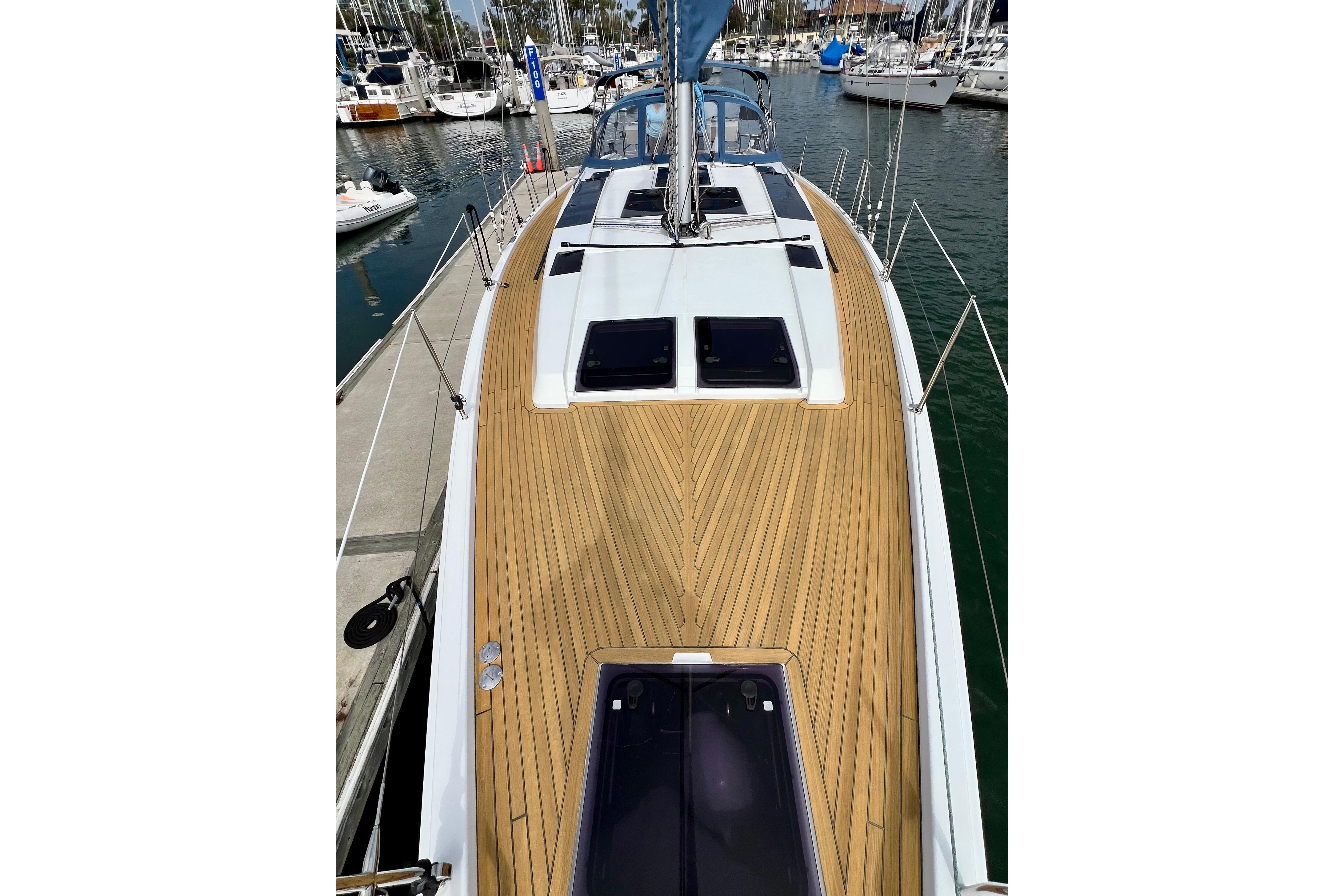 2016 Hanse 455 yacht with teak deck, docked in a marina.
