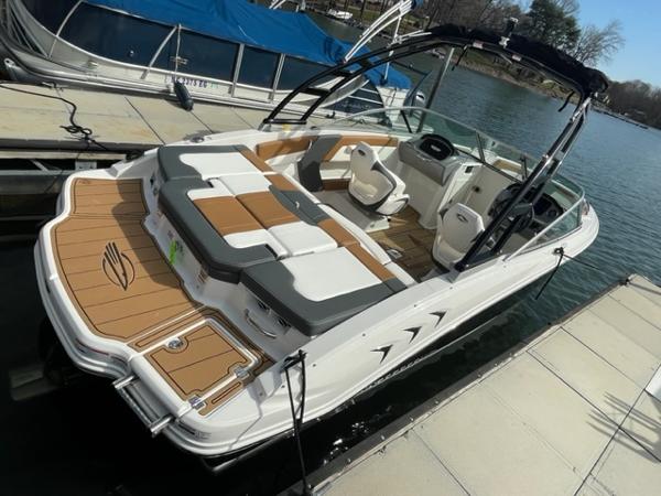 2025 Chaparral 21 SSi boat docked, featuring spacious seating and sleek design.