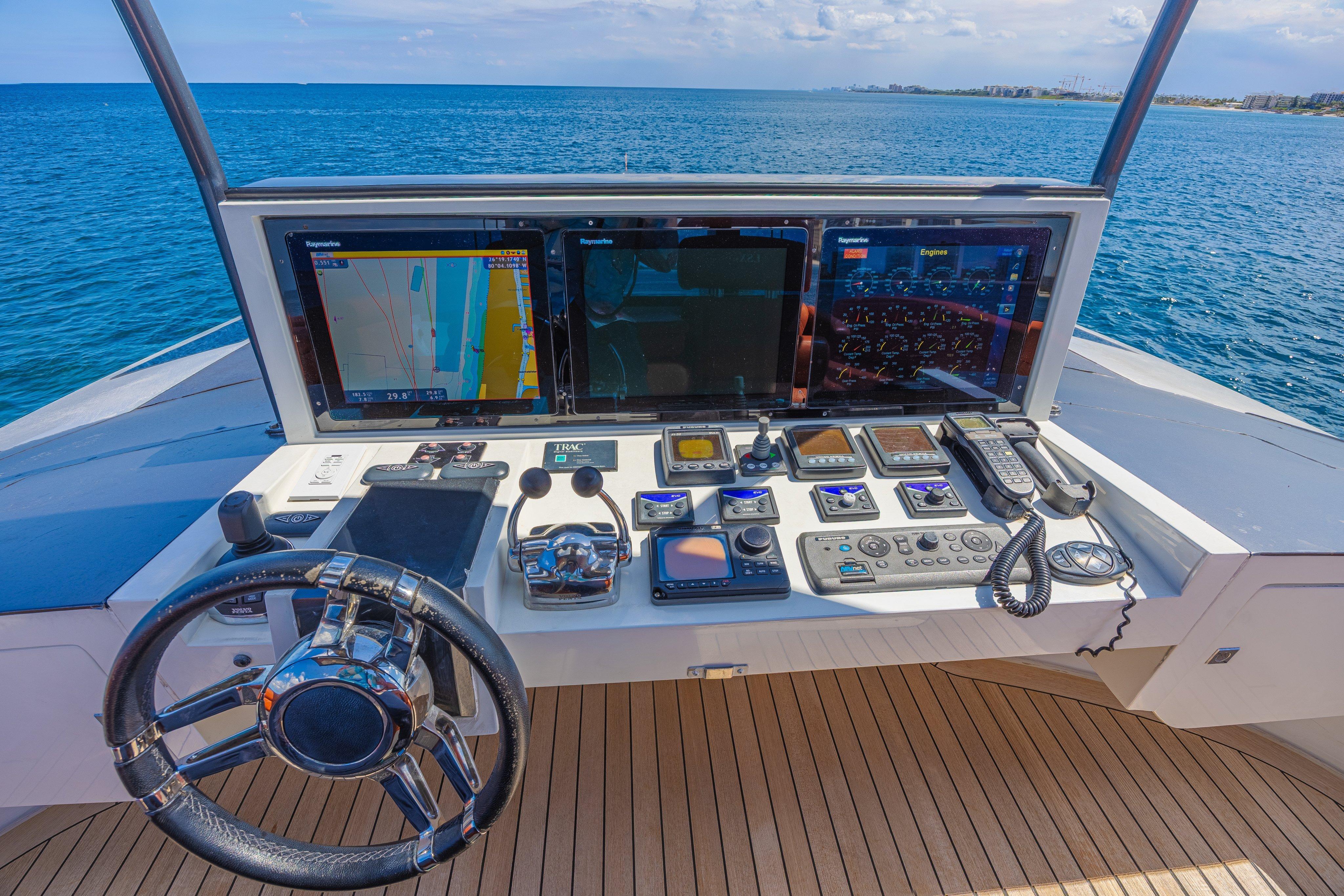 Helm of 2010 Lazzara LSX 92 yacht with advanced navigation controls and ocean view.
