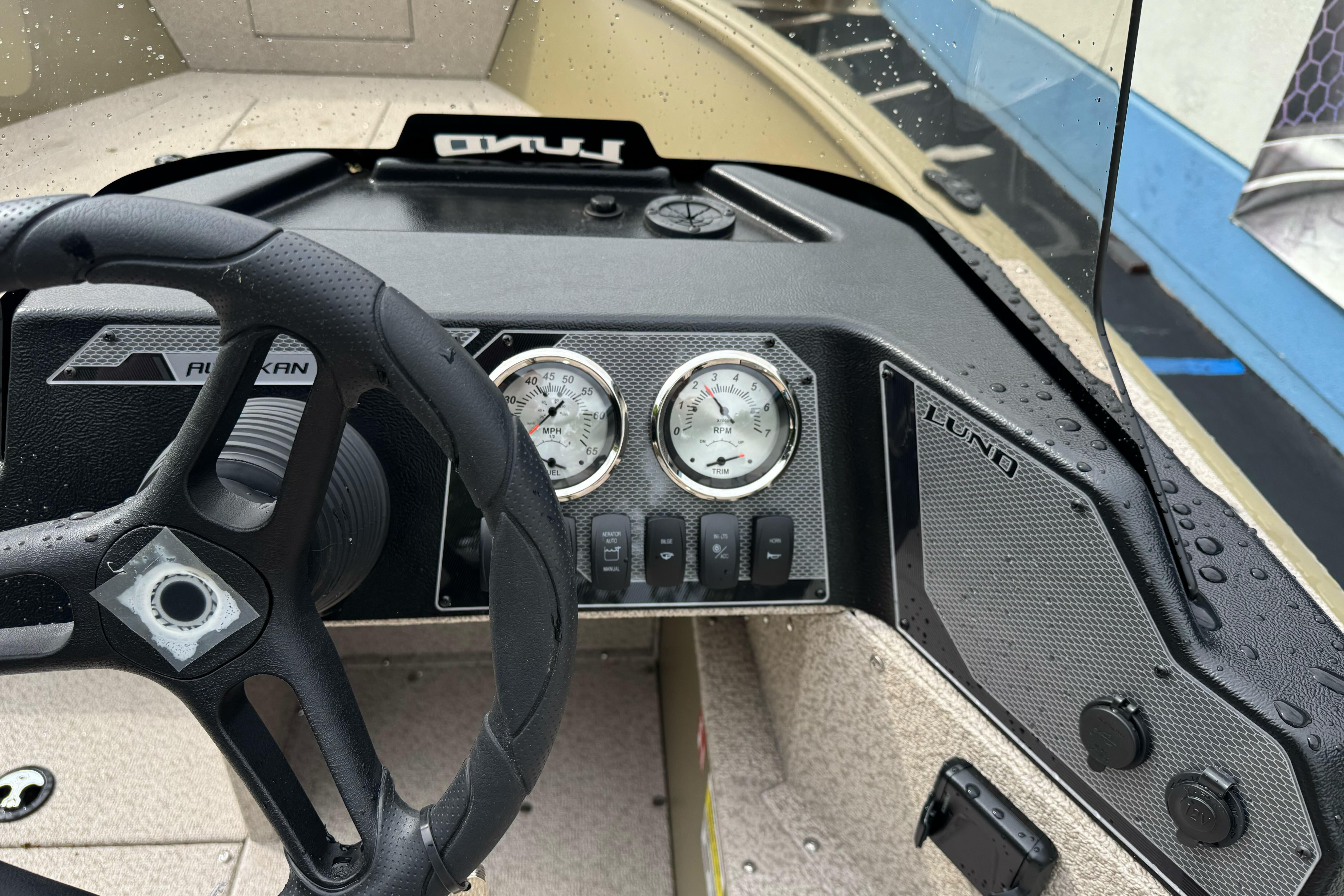 2026 Lund 2075 Alaskan SS boat dashboard with steering wheel and gauges.