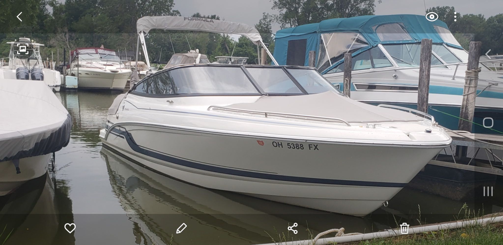 2019 Formula 240 boat docked in marina.