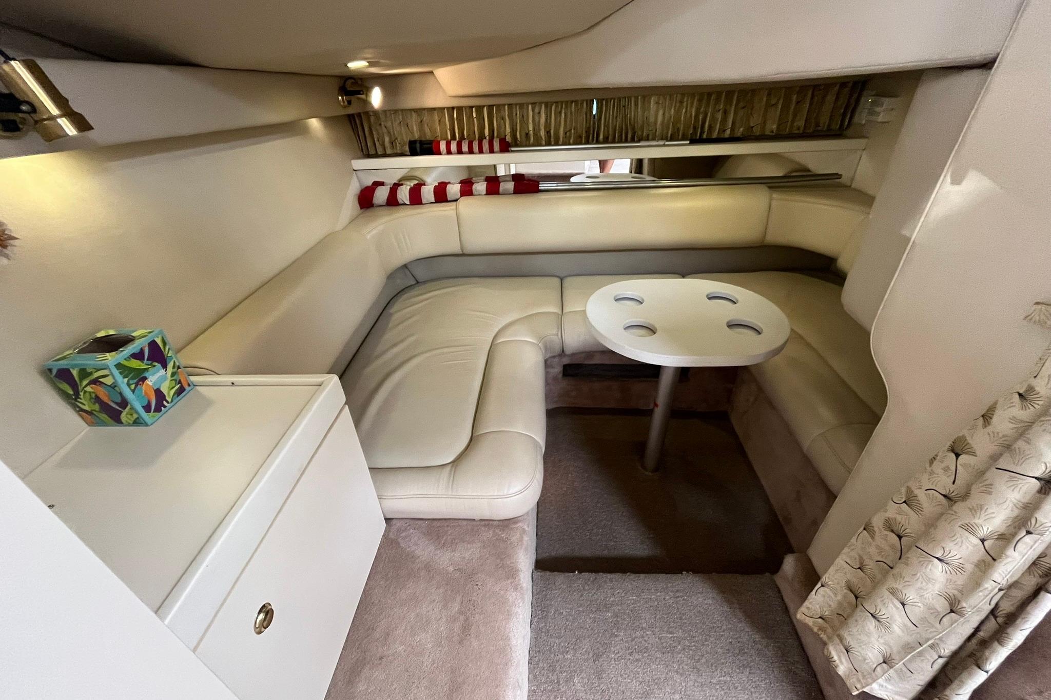 Interior of 1999 Formula 34 Performance Cruiser with cozy seating and table.