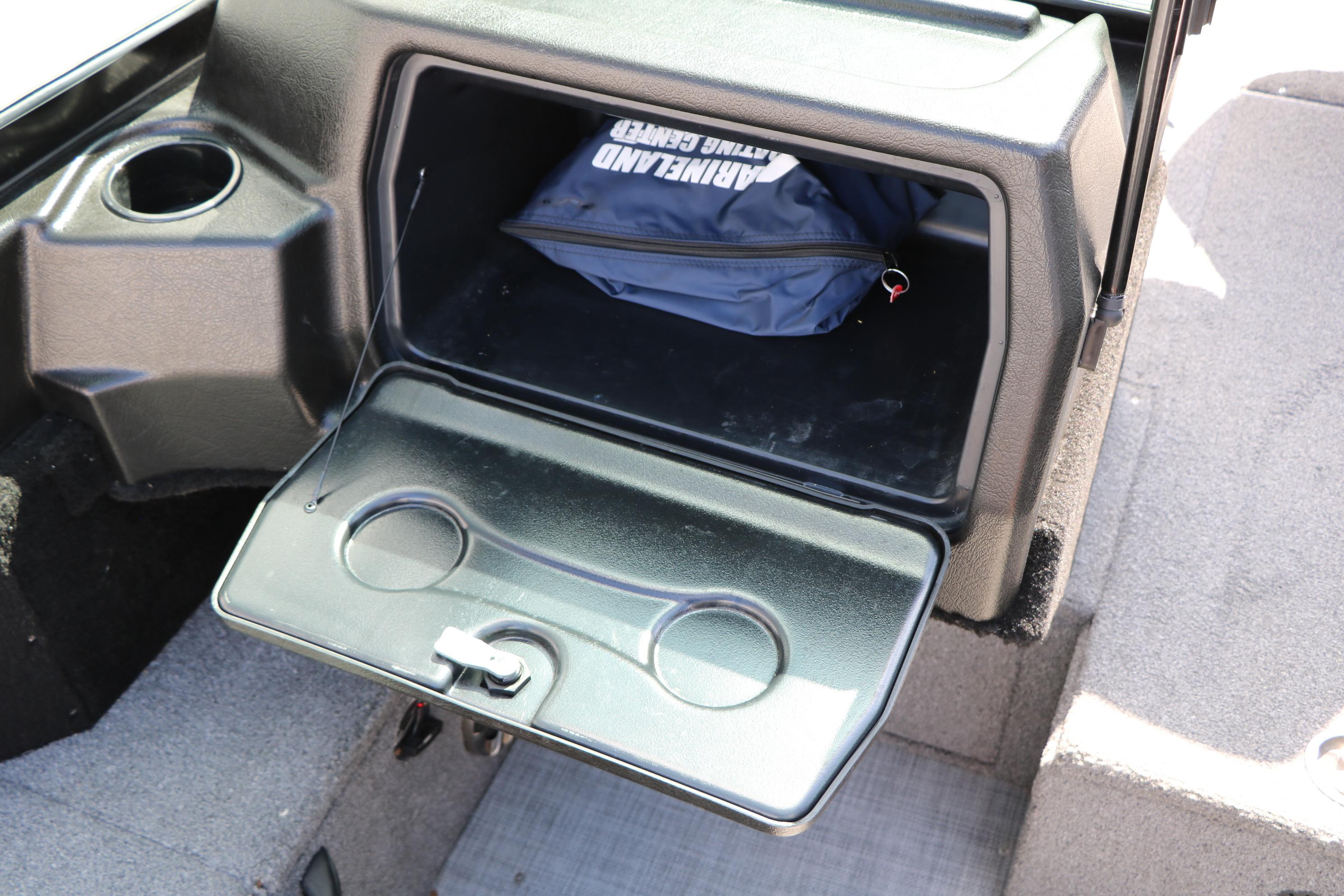 2023 Alumacraft Competitor FSX 185 boat storage compartment with cup holders and gear bag.