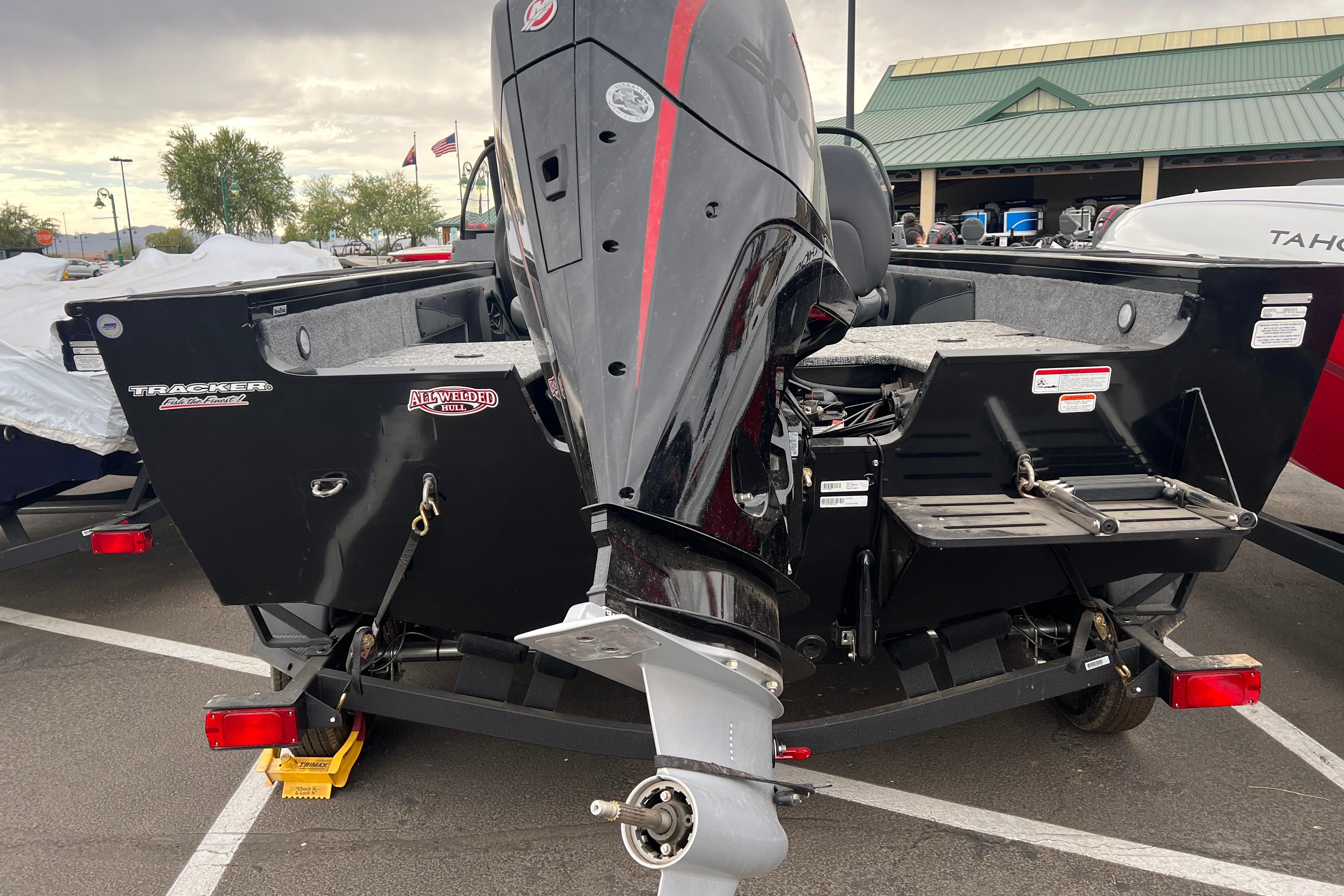 2026 Tracker Targa V-19 Combo boat with powerful outboard motor in a parking lot.