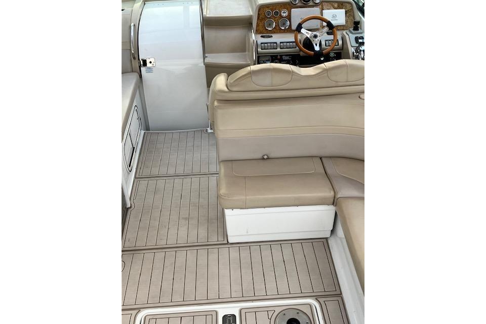 2009 Formula 350 Sun Sport boat interior with beige seating and wooden dashboard.