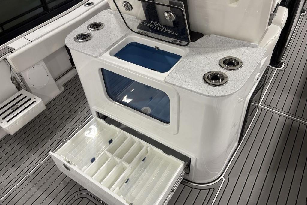 2026 Tidewater 3100 Carolina Bay boat interior with storage compartments and cup holders.