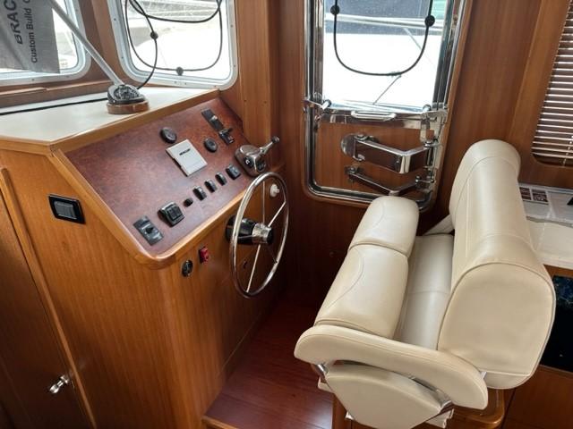 Interior helm of 2025 Bracewell 41 boat with steering wheel and controls.