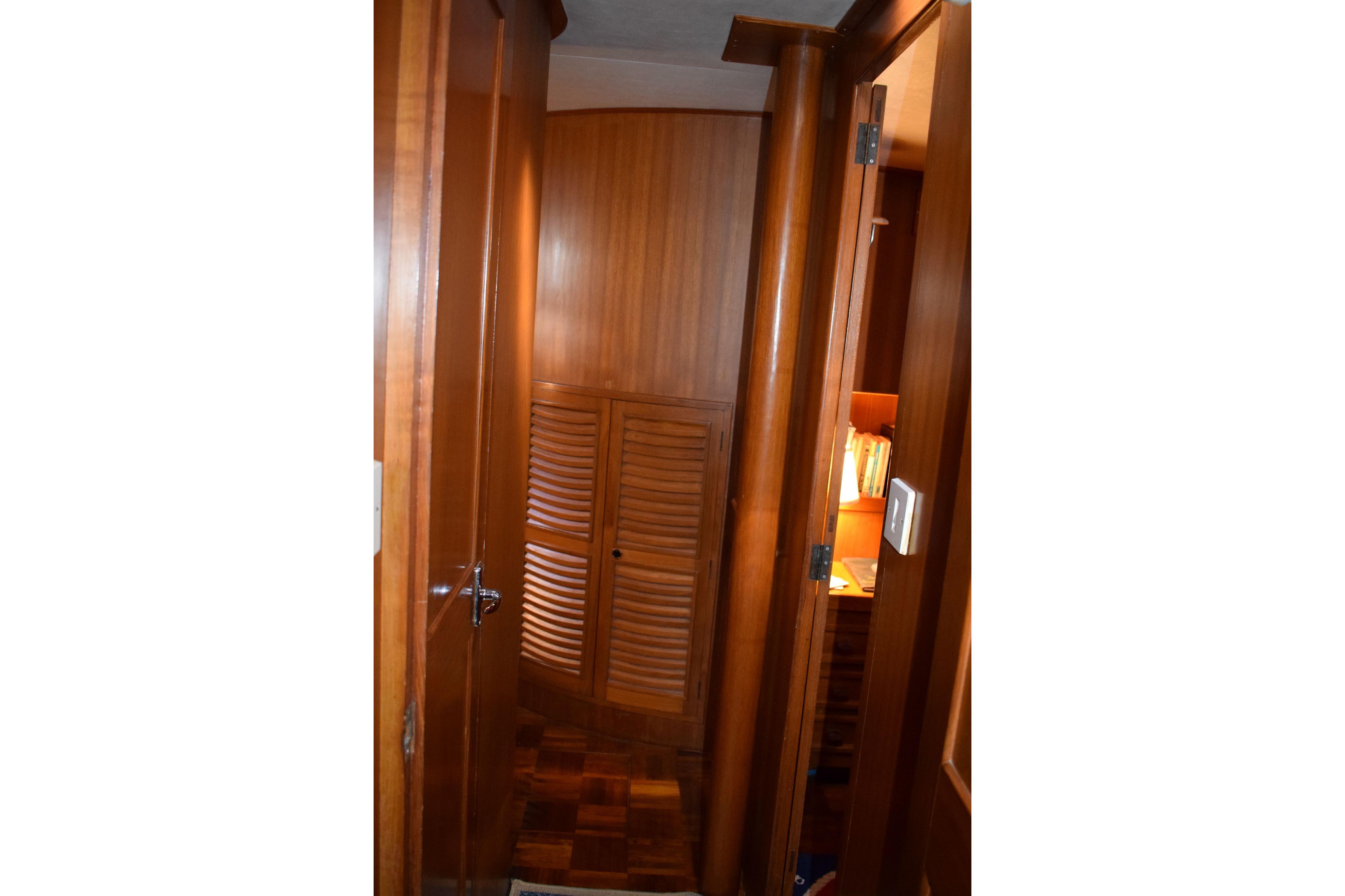 Interior of 1980 Cheoy Lee 52 Motorsailer with wooden cabinetry and cozy lighting.
