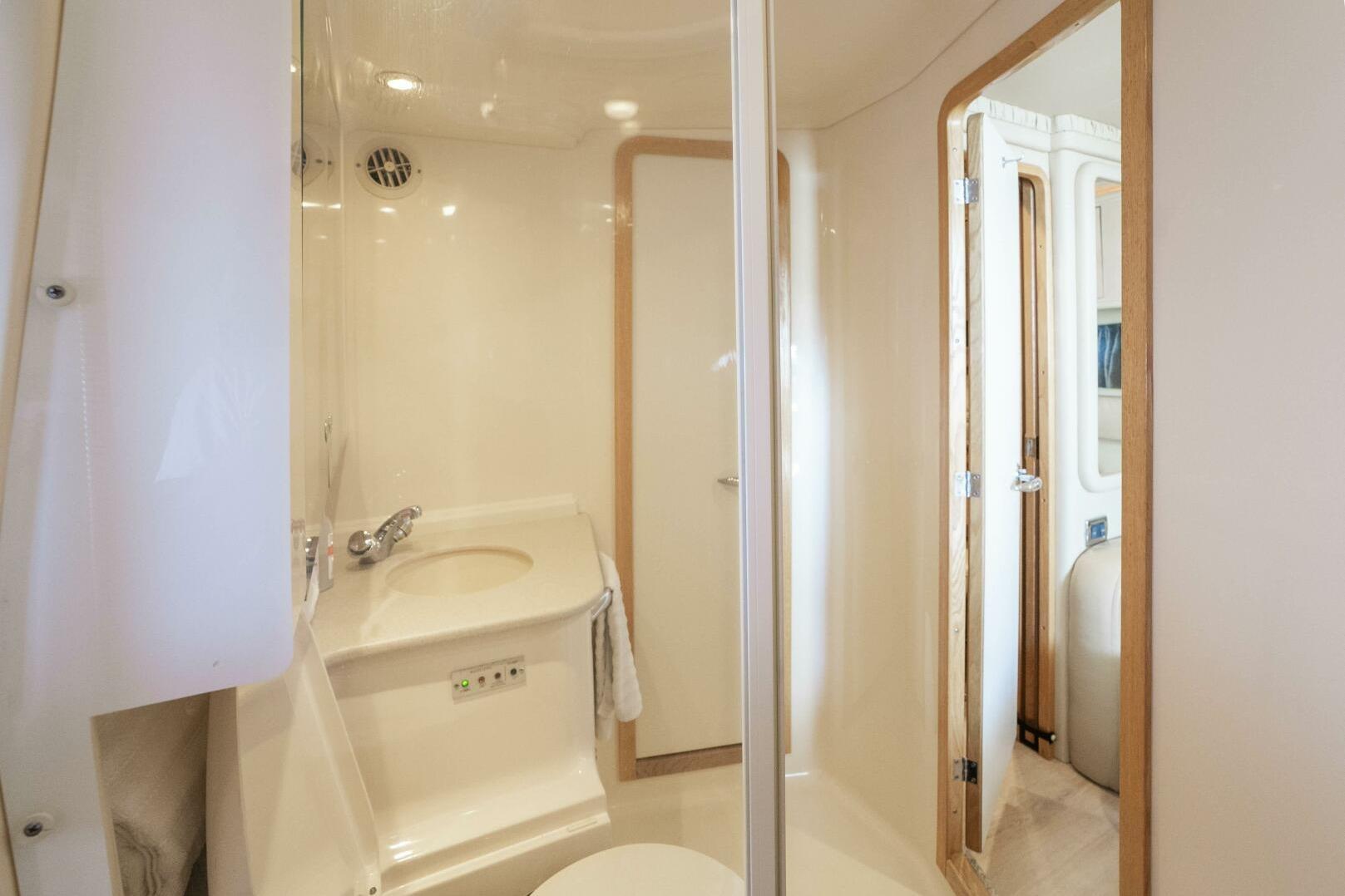 Bathroom interior of 2003 Sea Ray Sundancer 460 yacht, featuring sleek design and modern fixtures.