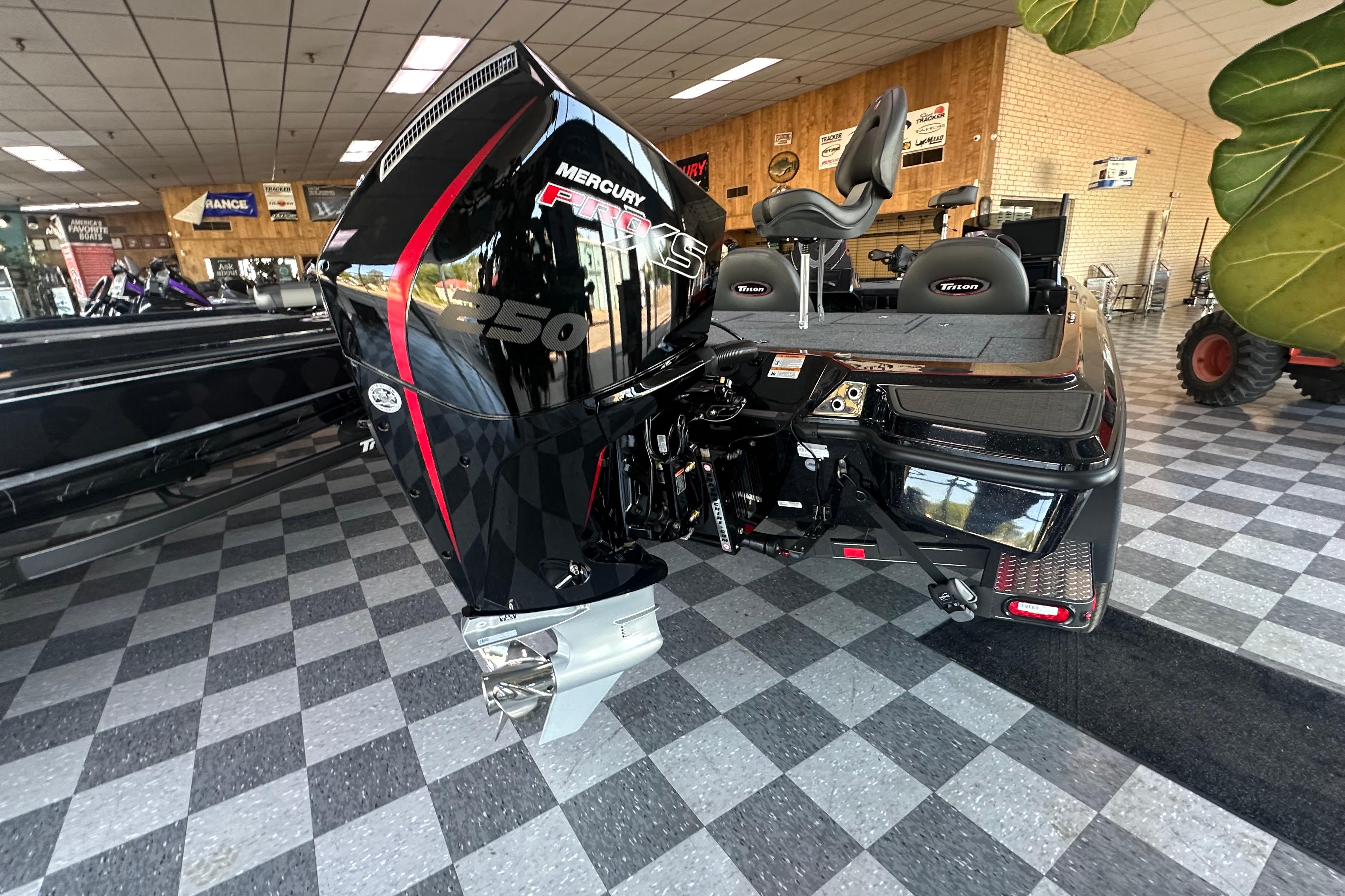 2026 Triton 20XP Patriot boat with Mercury 250 Pro XS engine in showroom.