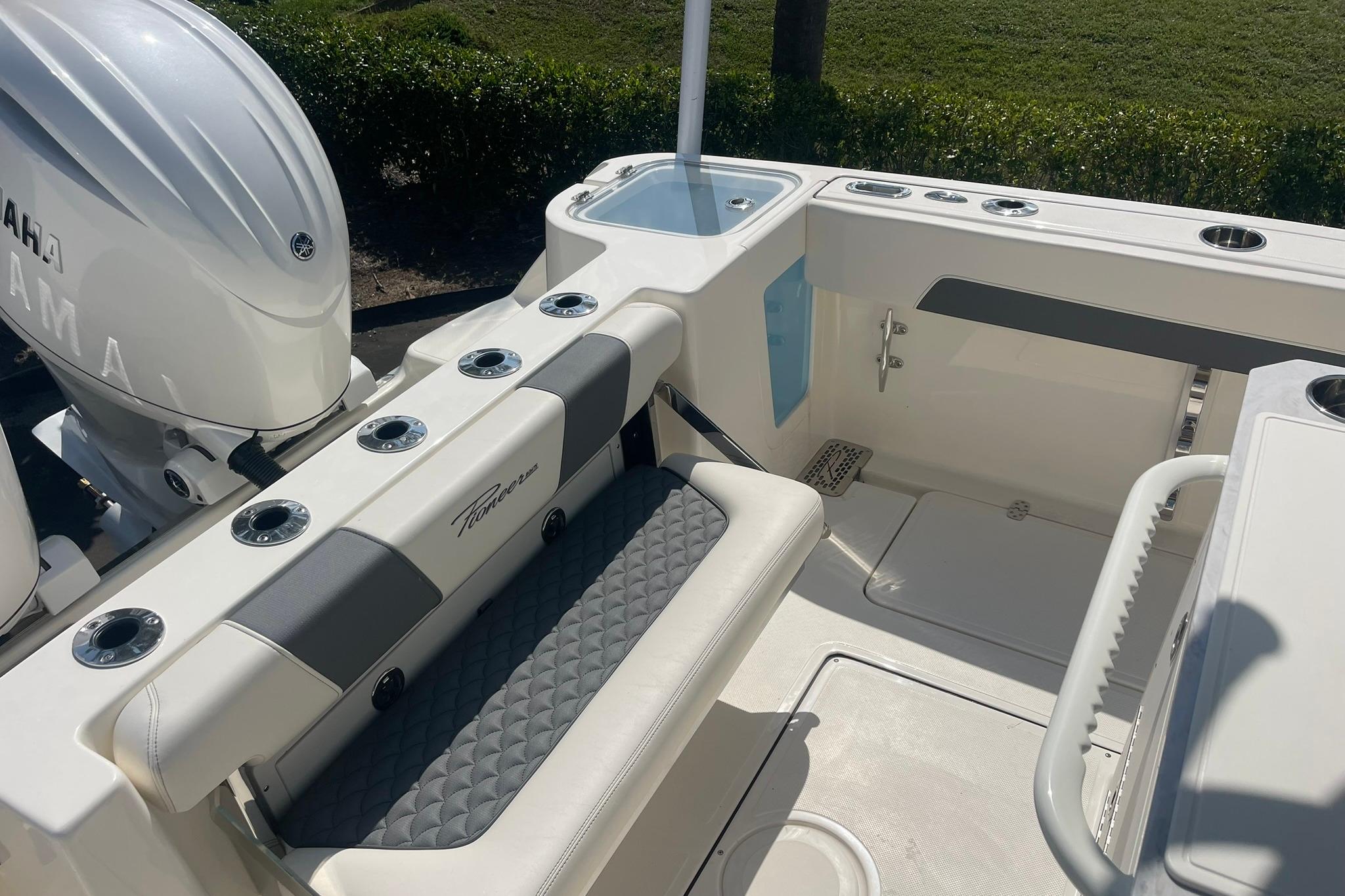 2026 Pioneer 250 Pelagic boat interior with Yamaha engine, featuring seating and fishing rod holders.