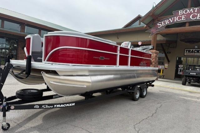 2026 Sun Tracker Party Barge 22 DLX pontoon boat on trailer at service center.