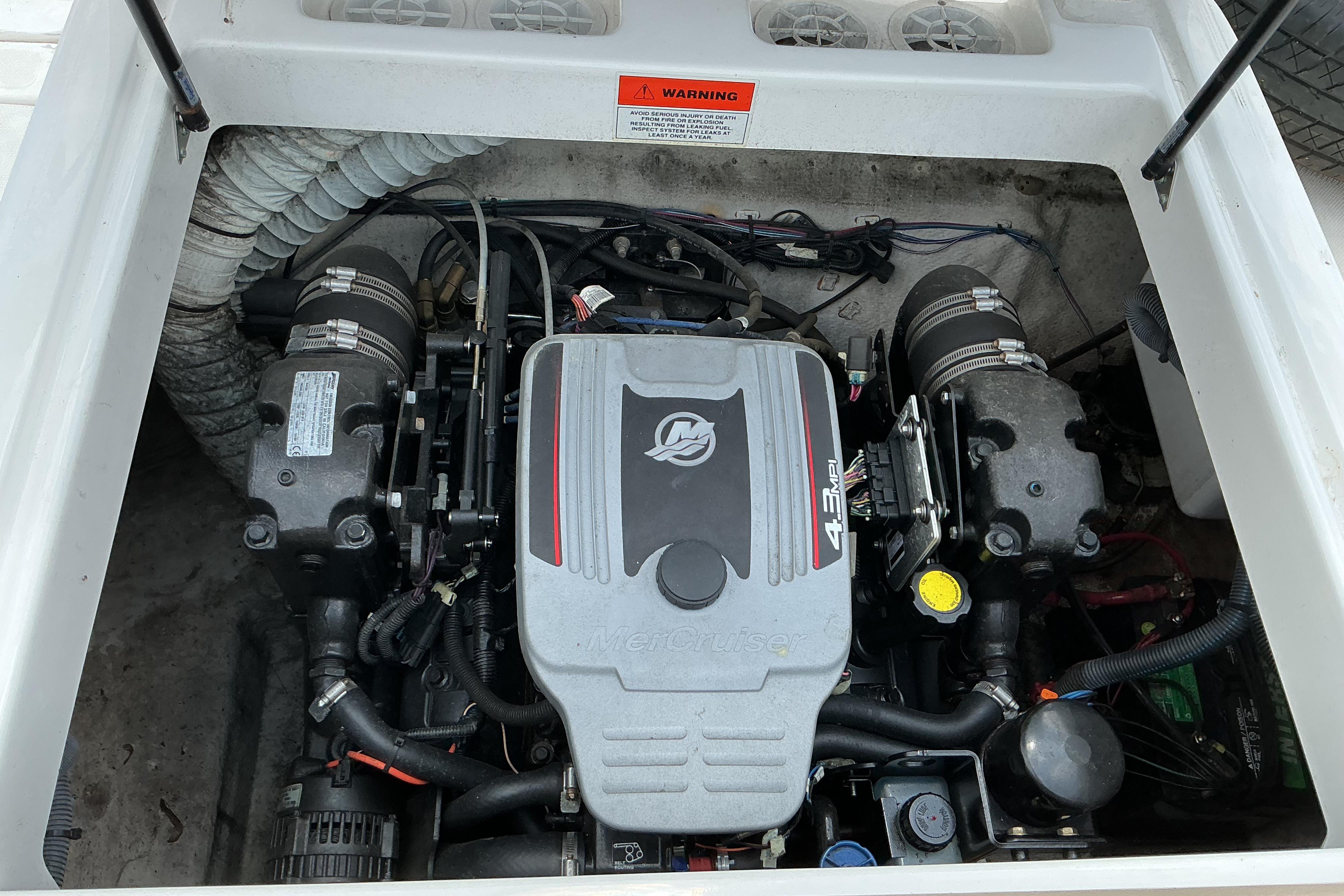 Engine compartment of a 2015 Hurricane SunDeck 187 IO boat, featuring a MerCruiser 4.3 MPI engine.