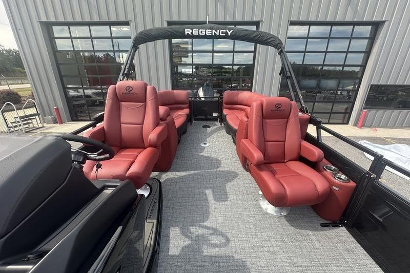 2026 Regency 230 DL pontoon boat with luxurious red seating and modern design.
