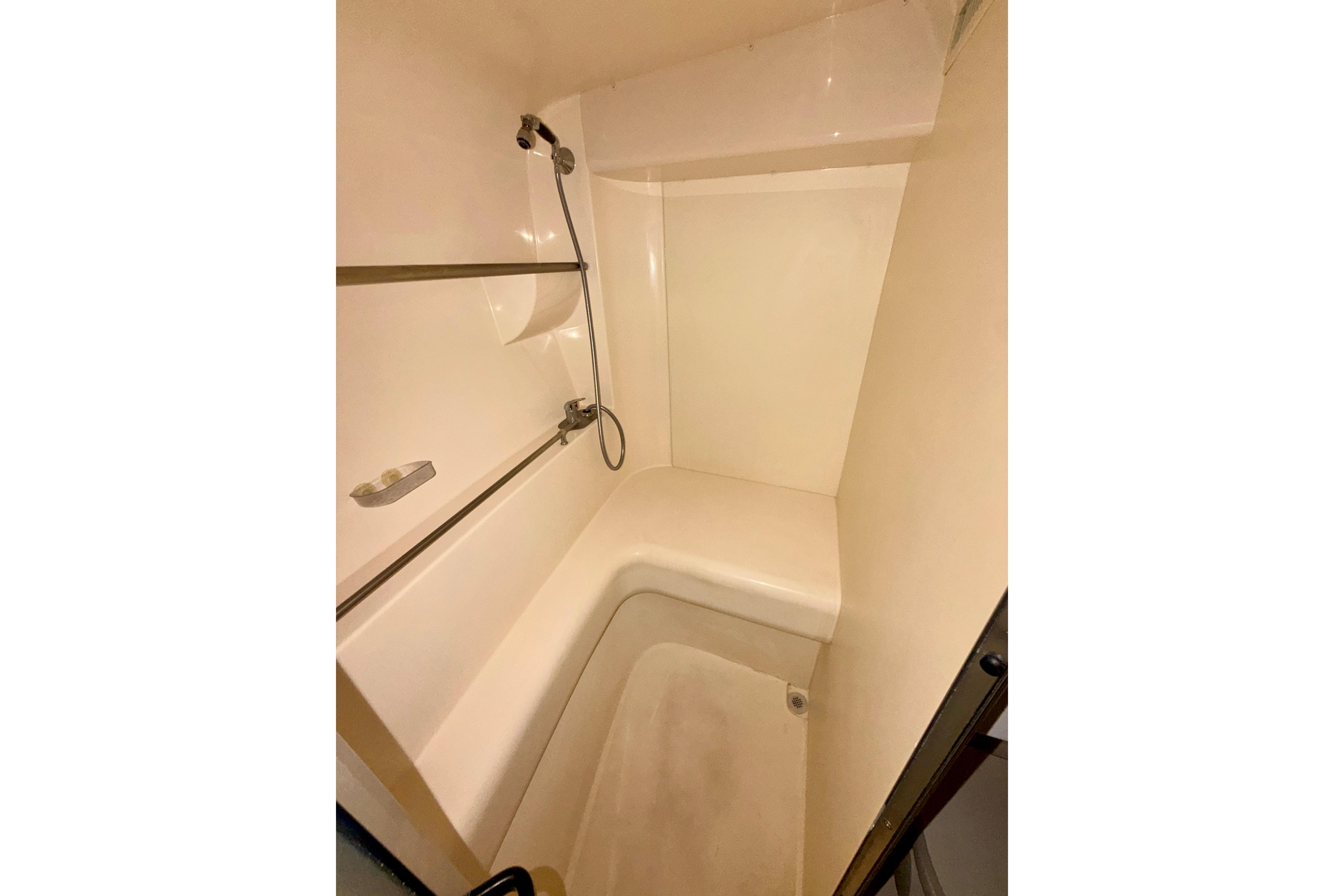 Shower area inside a 2000 Carver 350 Mariner yacht, featuring a handheld showerhead.
