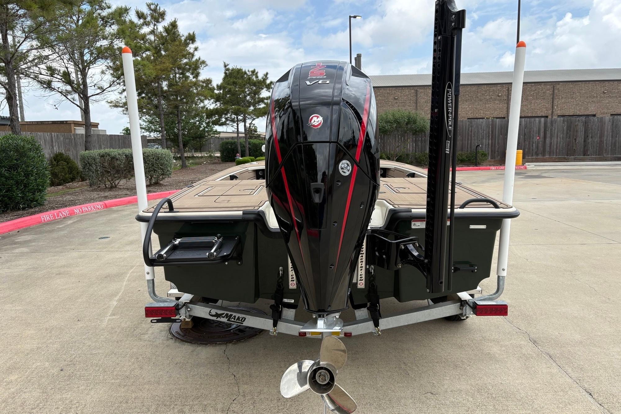 2025 Mako 18 Pro Skiff Backwater Edition boat with powerful V6 engine, parked outdoors.