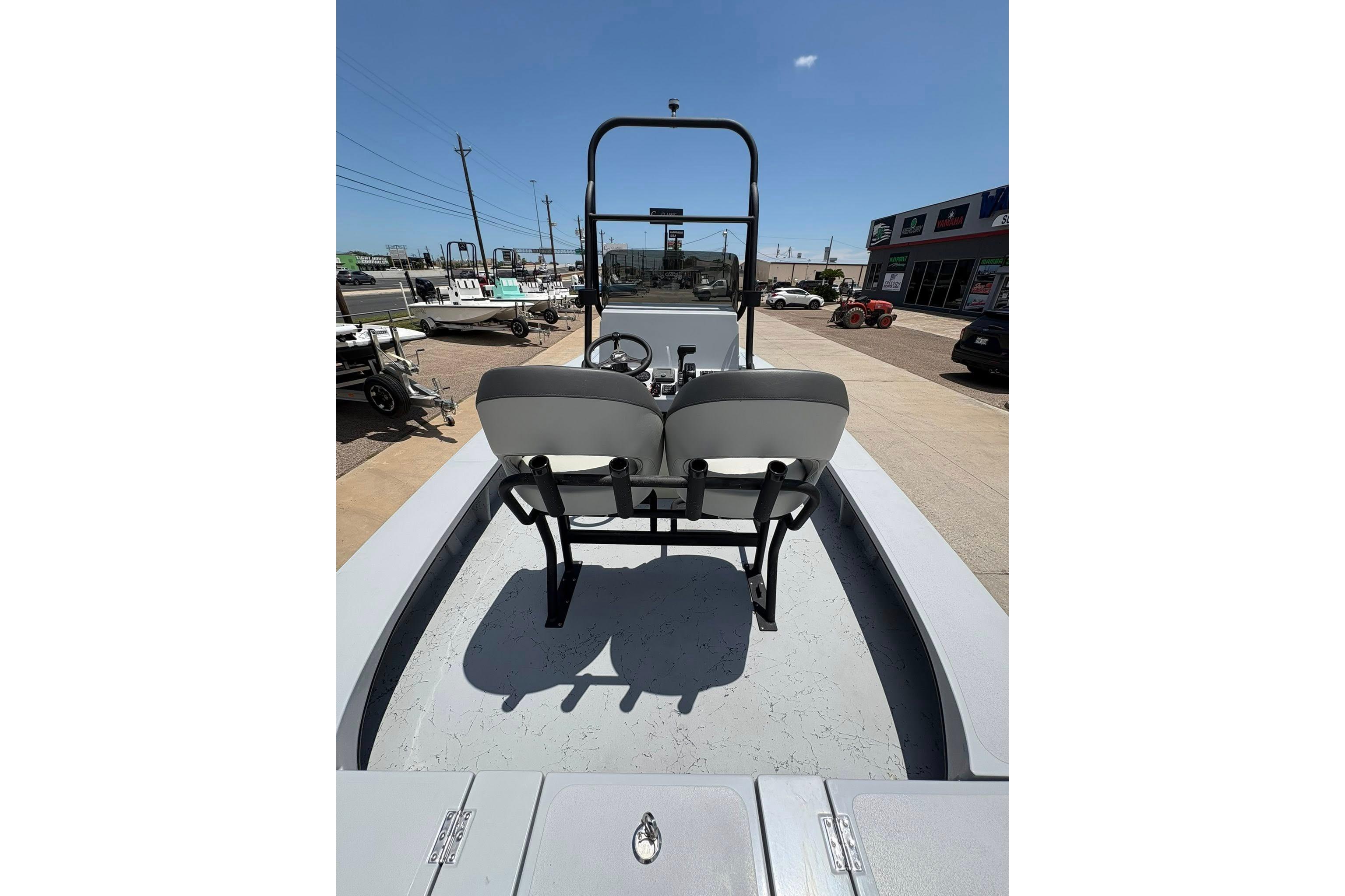 2026 Freedom Boats 23' Warrior with dual seats, parked outdoors under clear skies.