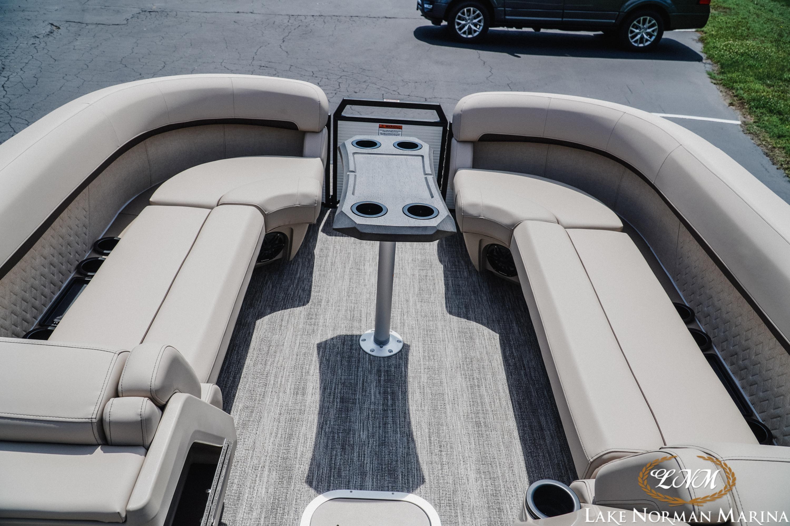 2026 Bennington 24MFB pontoon boat interior with plush seating and central table.