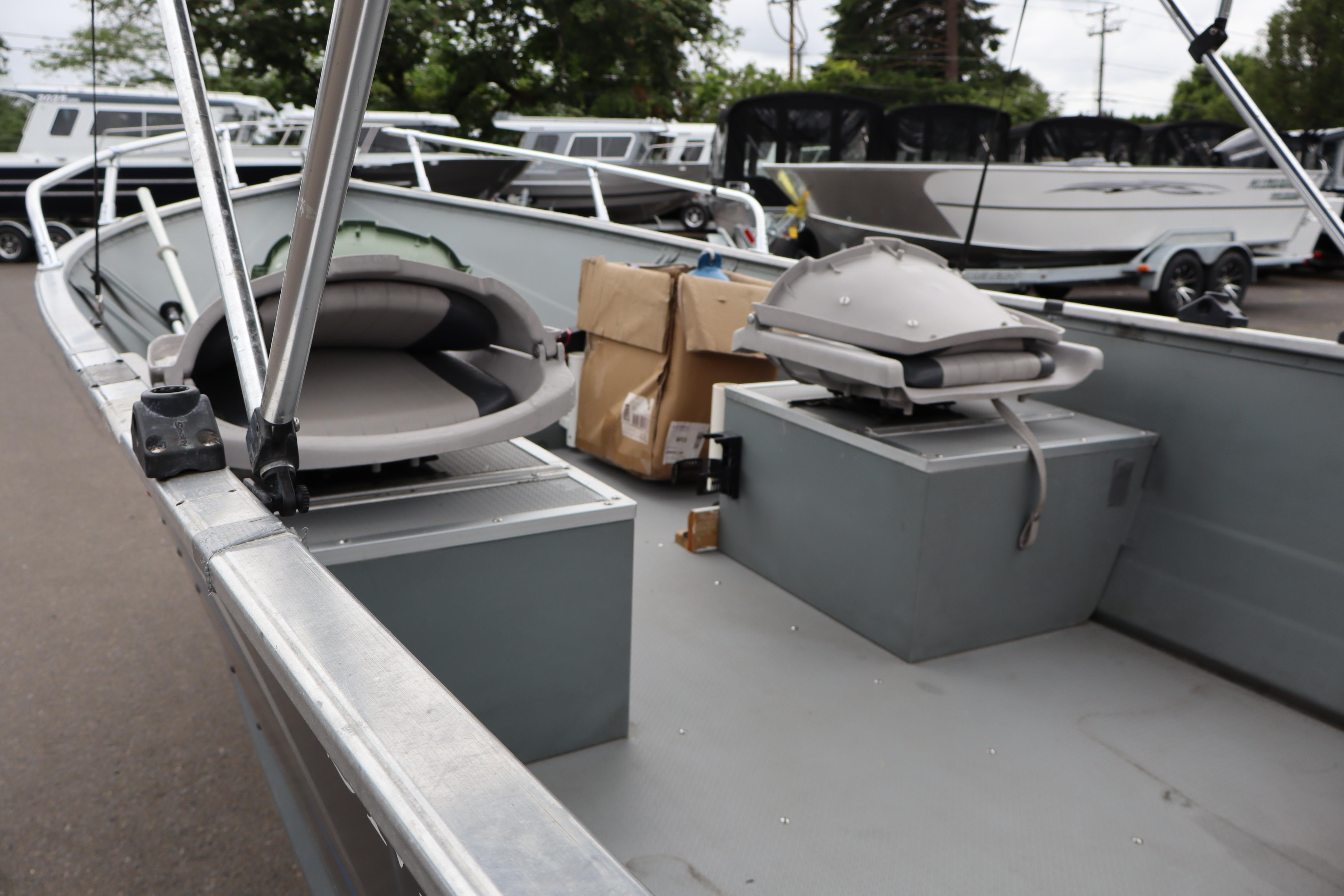 2006 Smoker Craft Alaskan 15 boat interior with seating and equipment, parked outdoors.