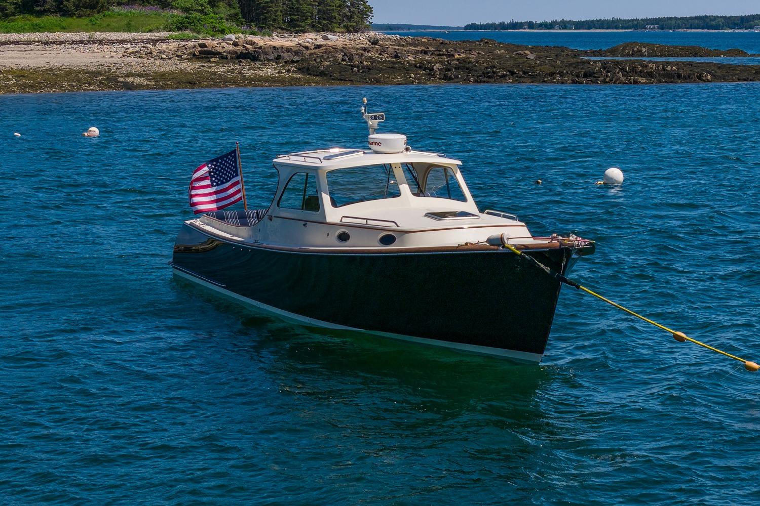 2001 Hinckley Picnic Boat 36 Classic anchored in scenic coastal waters.