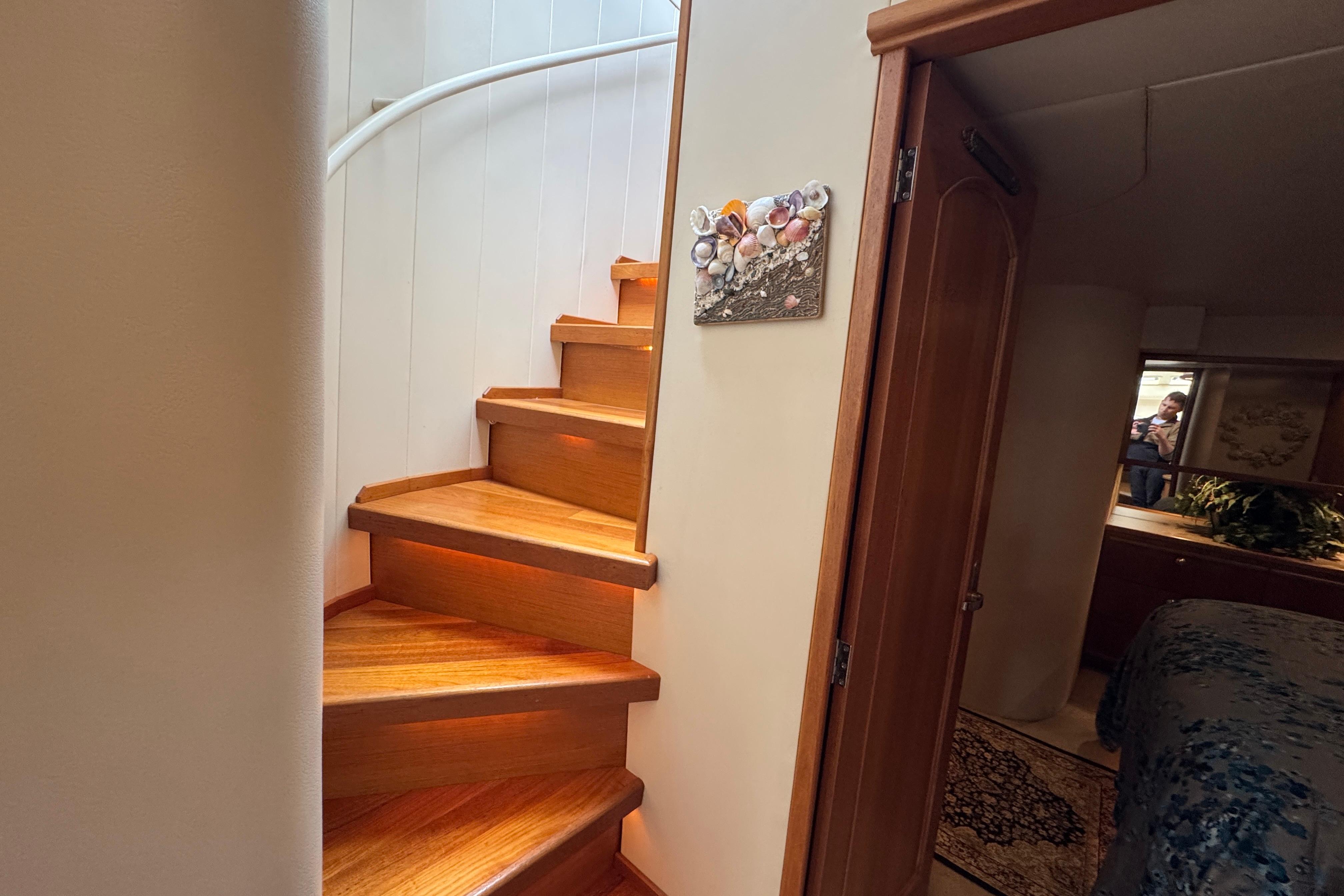 Interior of 1998 Bayliner 5788 Pilot House Motoryacht with wooden stairs and bedroom view.