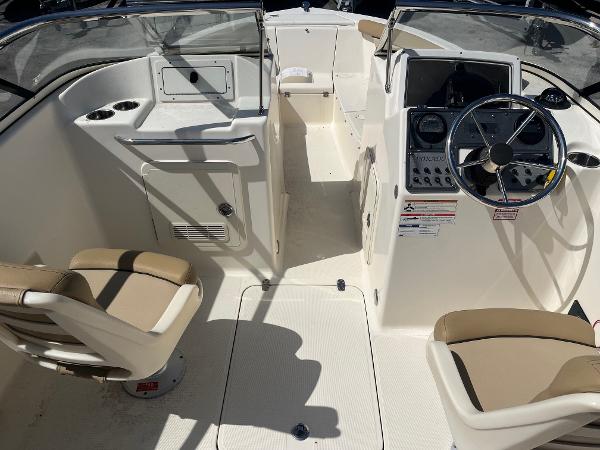 2018 Scout 210 Dorado boat interior with steering wheel and seating.