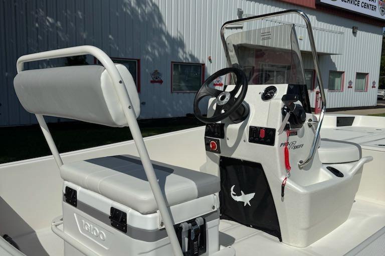 2026 Mako Pro Skiff 17 CC boat interior with steering console and seating.