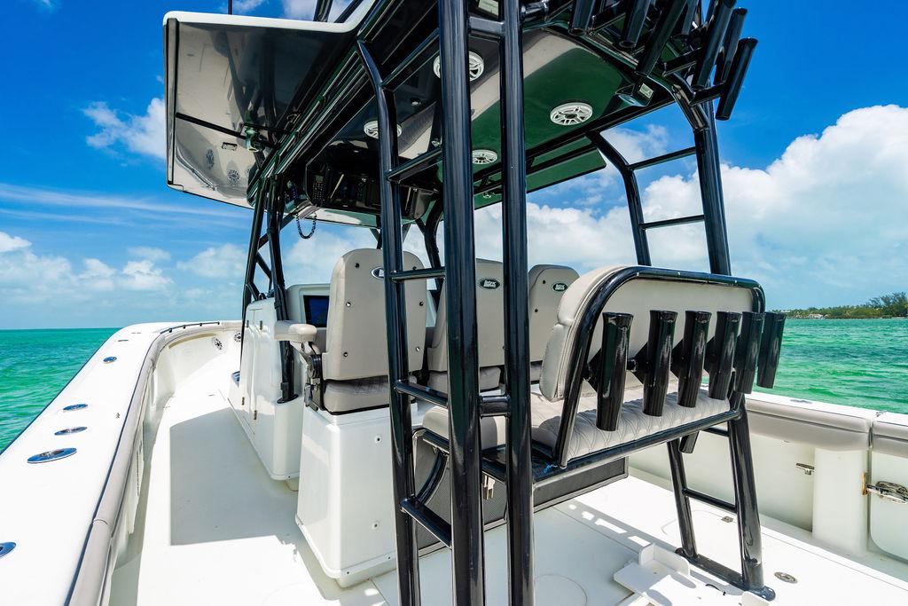 2015 Yellowfin CC boat interior with seating and rod holders, set against a clear blue sky.