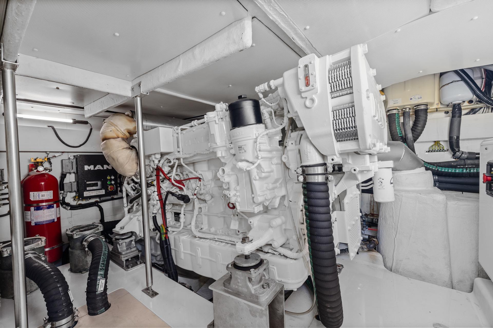 Engine room of a 2019 Azimut 55 yacht, featuring a MAN engine and fire safety equipment.