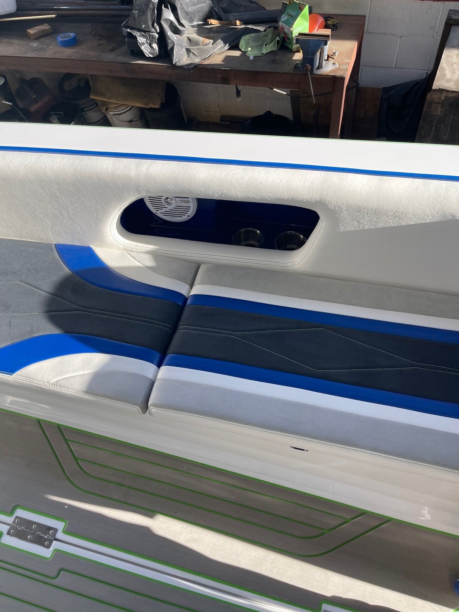 Interior of a Custom Barron 290s boat, seating area with blue accents.